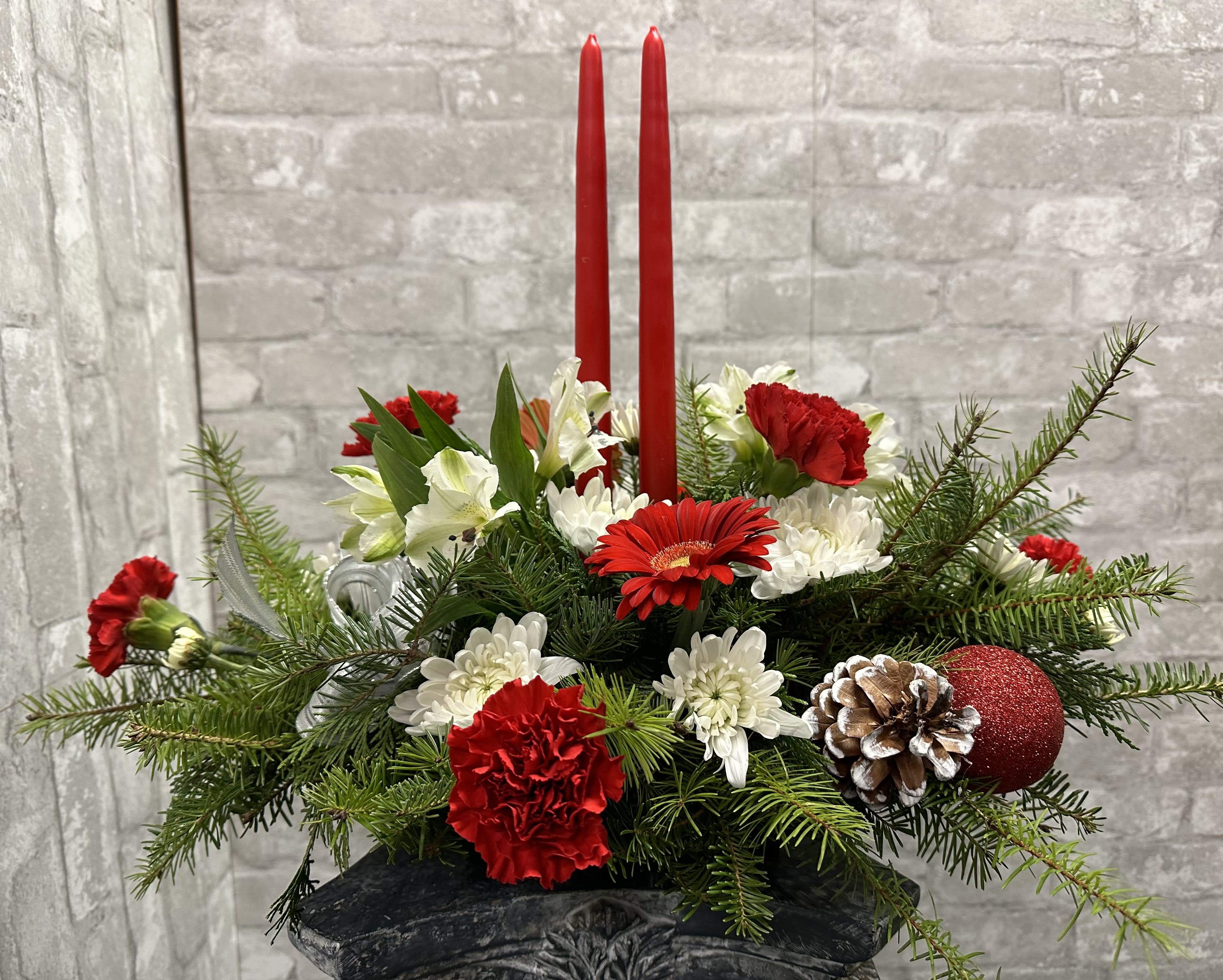 Holiday Candles Centerpiece FG751 - Marvelous double candle centerpiece to finish that holiday dining table.  Red and white flowers, including roses and gerbers, highlight this magical design.  Approximately 15&quot; H and 22&quot; W.