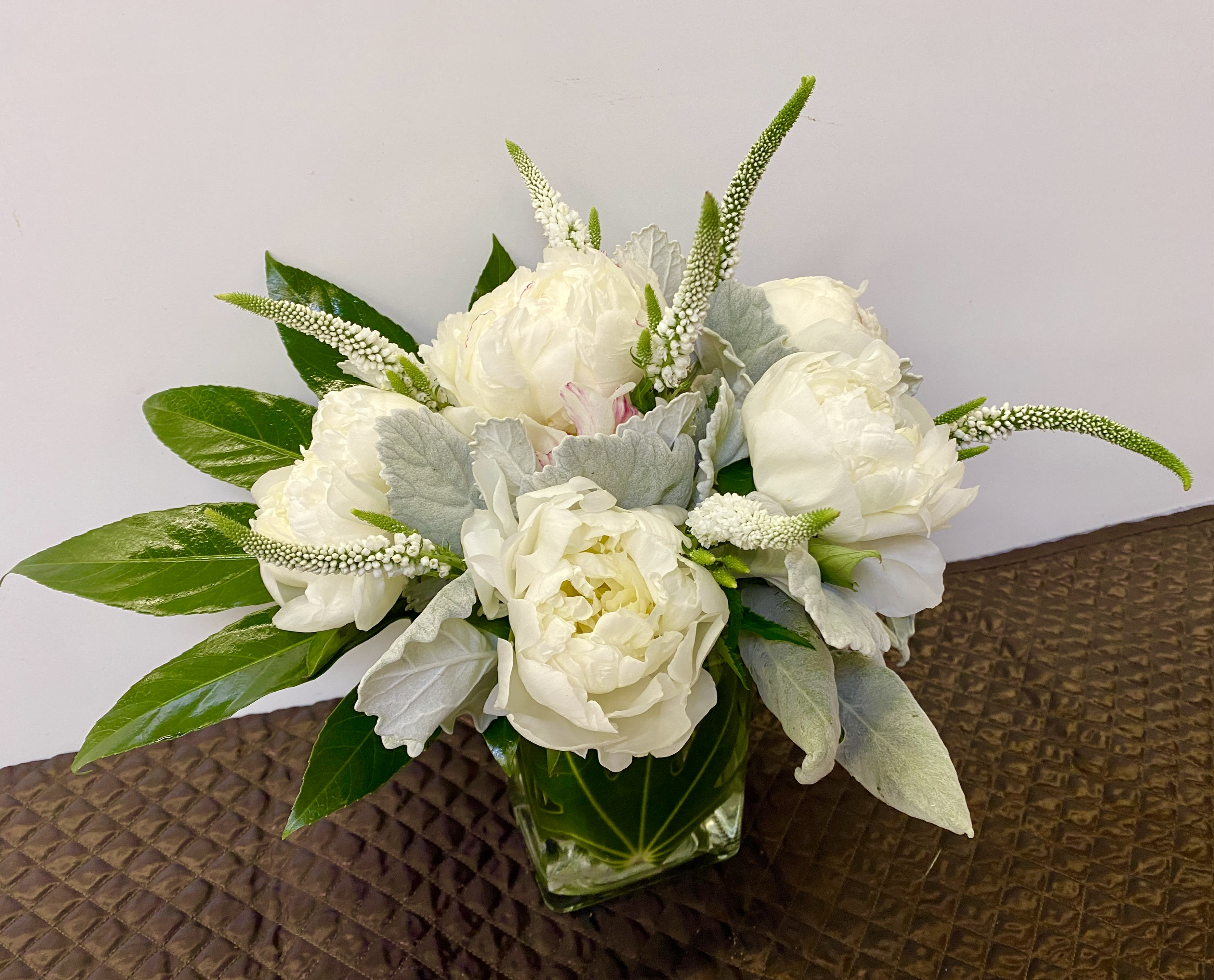 White snow - white peonies in a glass vase