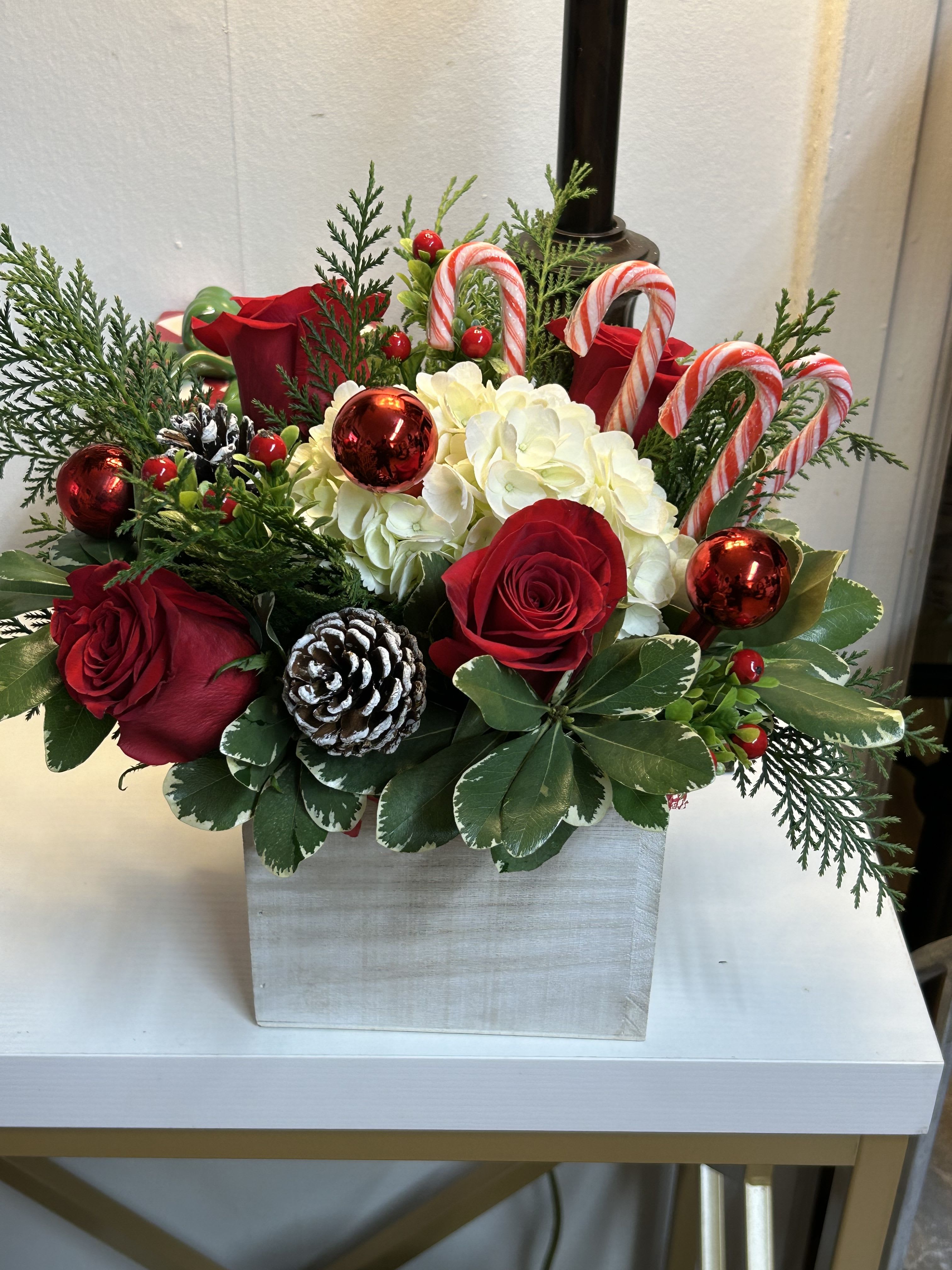 Candy Cane Arrangement  - White hydrangeas, red roses, premium Christmas greenery and candy canes in a wooden box