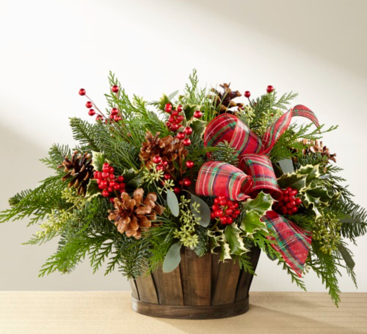 Winter Wonderland  - Beautiful  basket arrangement filled with  assorted  premium Christmas greenery  berries  pinecones accented with a beautiful Christmas ribbon 