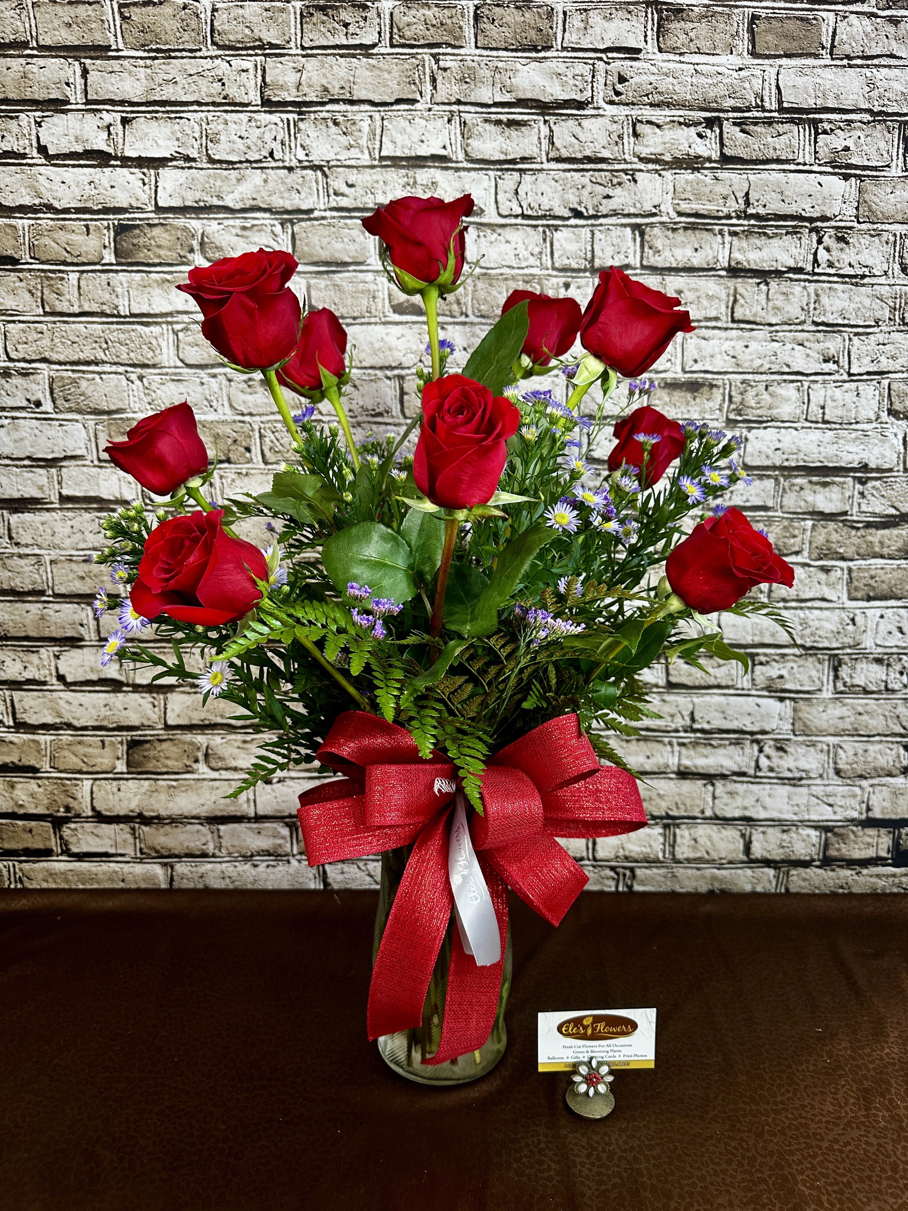 Passionate Roses - Indulge in classic beauty with our Passionate Roses arrangement, featuring one dozen premium roses artfully arranged in a vase with lush fresh greenery and delicate accent flowers. Whether it's a romantic gesture, a heartfelt gift, or a stunning décor piece, this breathtaking bouquet adds grace and charm to any setting. Handcrafted with care, it's a timeless expression of love, appreciation, and celebration. Many color options and combinations available. Shown in all red or pink and red.   Perfect for anniversaries, birthdays, or just because!   STANDARD PRICE: ONE DOZEN LONG STEM ROSES, ACCENT FLOWERS, GREENERY ALL ARRANGED IN A VASE.  DELUXE PRICE: ONE DOZEN LONG STEM ROSES, ADDED FLORAL BLOOMS (like carnations, alstroemeria, lisianthus, daisies, lilies etc.) , ACCENT FLOWERS, GREENERY ALL ARRANGED IN A VASE.  Approximate Dimensions: 26&quot;H x 23&quot;W