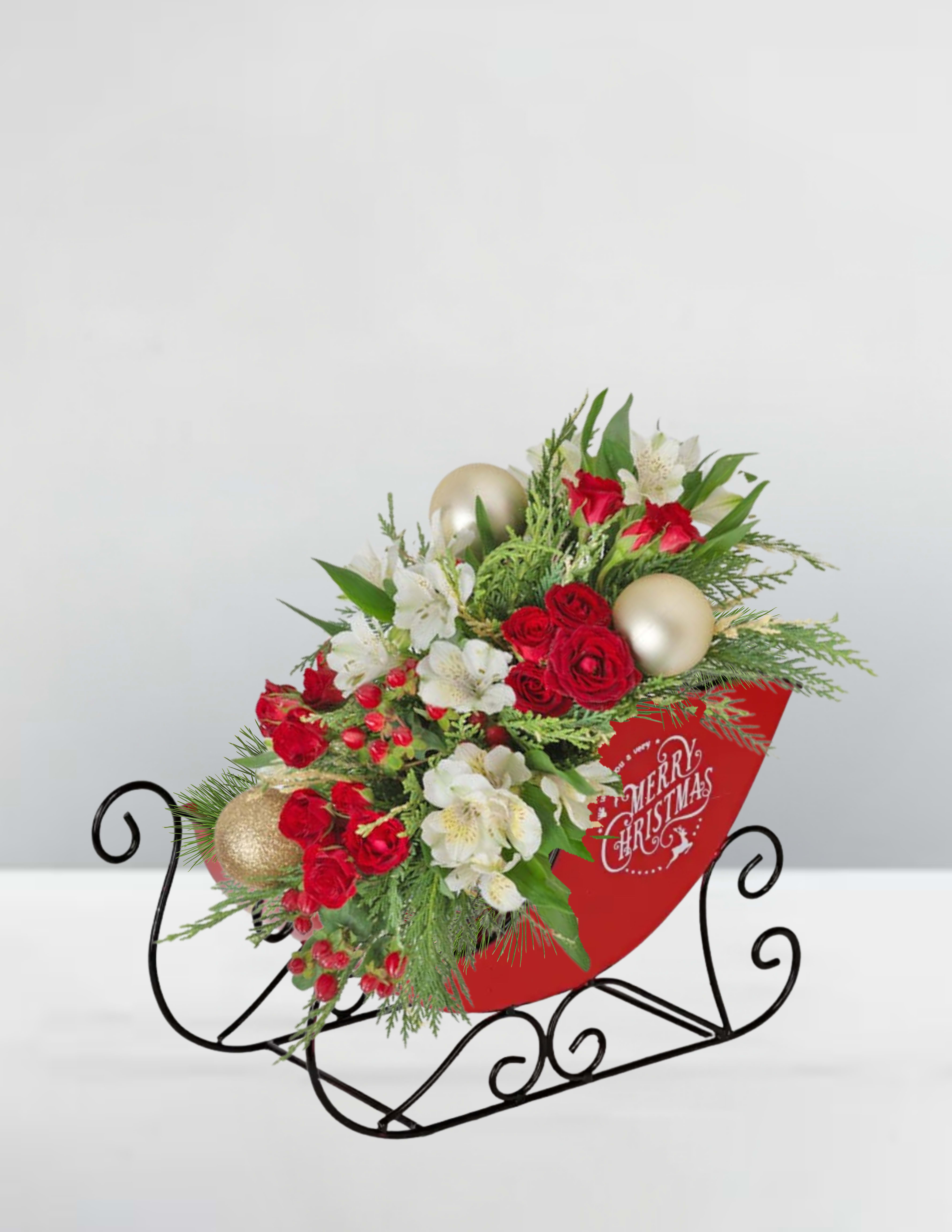 Golden Hearth -  Golden Hearth  A radiant centerpiece of holiday warmth, Golden Hearth brims with velvety red roses, snowy white alstroemeria, and lush evergreens, accented by shimmering gold ornaments and ruby berries. Nestled in a vintage sleigh with festive script, this arrangement captures the glow of a crackling fire and the sparkle of Christmas magic—inviting joy, comfort, and celebration into every home.