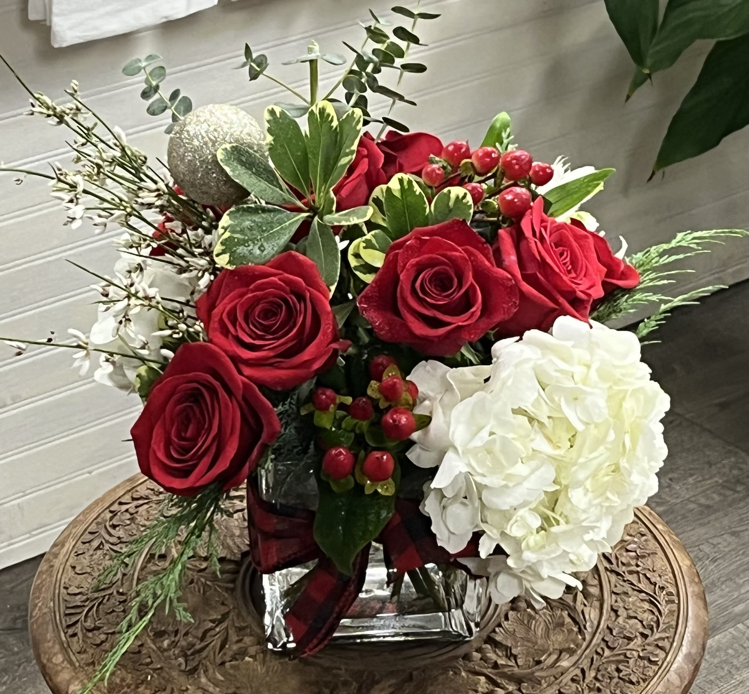 Deck The Halls - A festive arrangement of white hydrangea, red roses, berries and more.