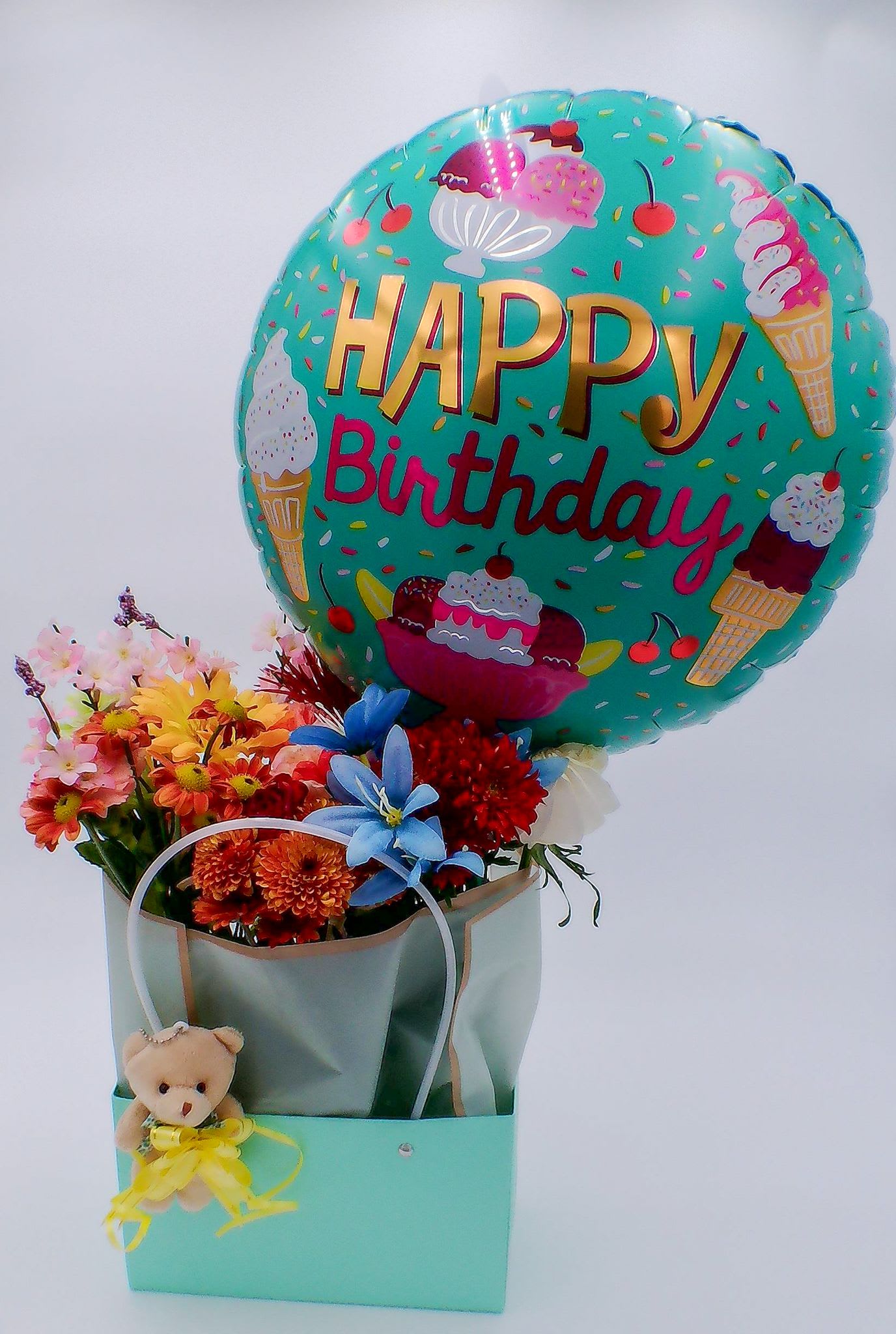 &quot;Happy Birthday&quot; Flower Gift Bag with Balloon and Teddy Bear - Mixed Fresh Flowers (12–14 stems): a colorful blend of 6 carnations,  2 chrysanthemums, 2 daisies, and  2 lilies. 18-inch Happy Birthday Foil Balloon (1 pc) Mini Teddy Bear (11 cm / 6 cm)  Reusable Gift Bag (32.5cm*22cm*13cm) Total Weight:700 g