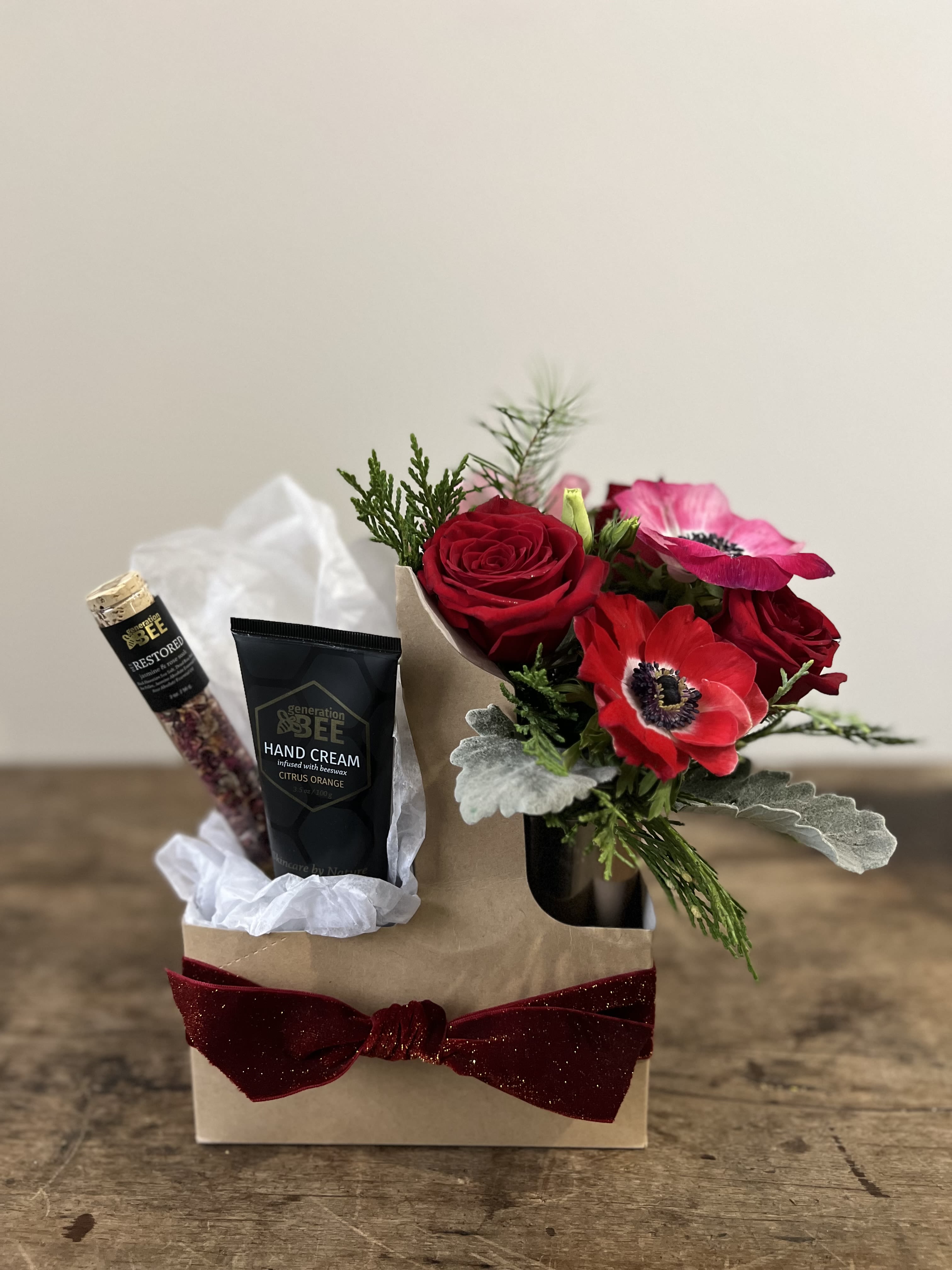 Seasonal Bud, Bath, and Balm Gift Set - Introducing our exquisite Gift Set, curated to elevate your self-care routine and brighten your space with a touch of natural beauty. Nestled in a  convenient carrier, this set includes:  1. Luxury Hand Cream: Treat your hands to the nourishing embrace of our luxurious hand cream. Infused with botanical extracts and moisturizing agents, it deeply hydrates and softens your skin, leaving it silky-smooth and delicately scented.  2. Bath Soak: Immerse yourself in a moment of pure relaxation with our indulgent bath soak. Enriched with minerals and soothing ingredients, it transforms your bath into a spa-like experience, helping you unwind and rejuvenate both body and mind.  3. Ceramic Bud Vase with Fresh Flowers: Adorn your space with the beauty of fresh flowers presented in a charming ceramic bud vase. Each bloom is carefully selected to add a touch of natural elegance and a pop of color to your surroundings.  Whether you're treating yourself or delighting a loved one, this Gift Set is a perfect expression of care and thoughtfulness. Elevate your daily routine, pamper your senses, and brighten your space with our beautifully curated Gift Set.  *Seasonal colors and presentation.