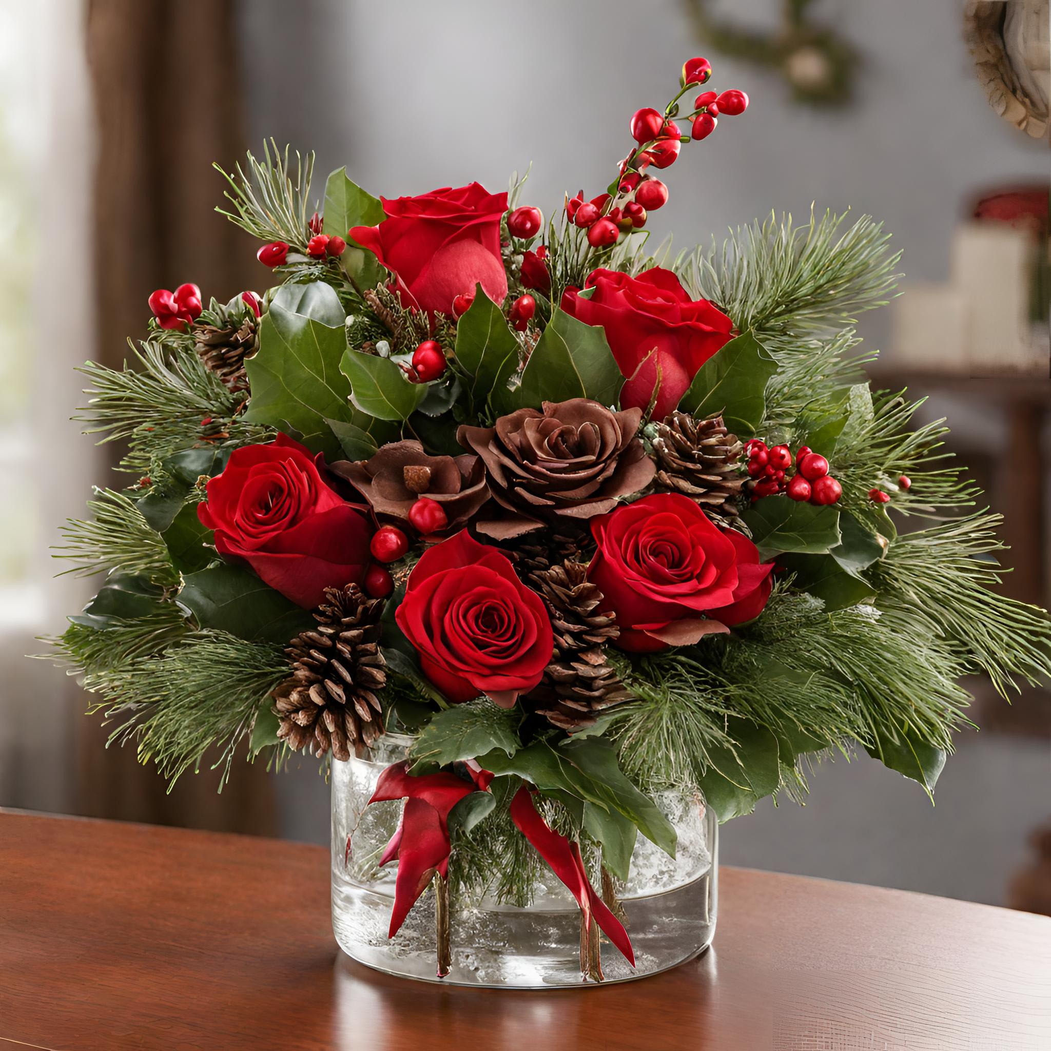Festive Winter Whispers - Spread the holiday cheer with Festive Winter Whispers, a small Christmas arrangement that captures the essence of the season. This charming composition features red roses, Christmas greens, and festive fillers artfully arranged in a vase. The combination of vibrant reds and lush greens creates a joyful harmony, making it the perfect addition to your holiday celebrations. Bring the magic of Christmas to any space with this heartwarming arrangement that whispers of winter's beauty.