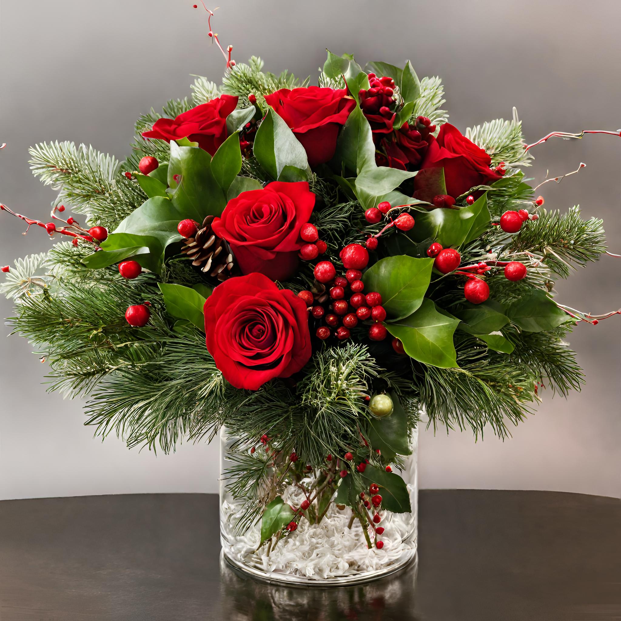 Merry Berry Bouquet - Embrace the spirit of the season with the Merry Berry Bouquet, a delightful Christmas arrangement that blends the richness of red roses with the charm of Christmas greens and festive fillers. Nestled in a small vase, this arrangement is a visual symphony of holiday hues, evoking warmth and merriment. Share the joy of Christmas with loved ones by gifting them this merry bouquet, a perfect embodiment of festive cheer and timeless beauty.