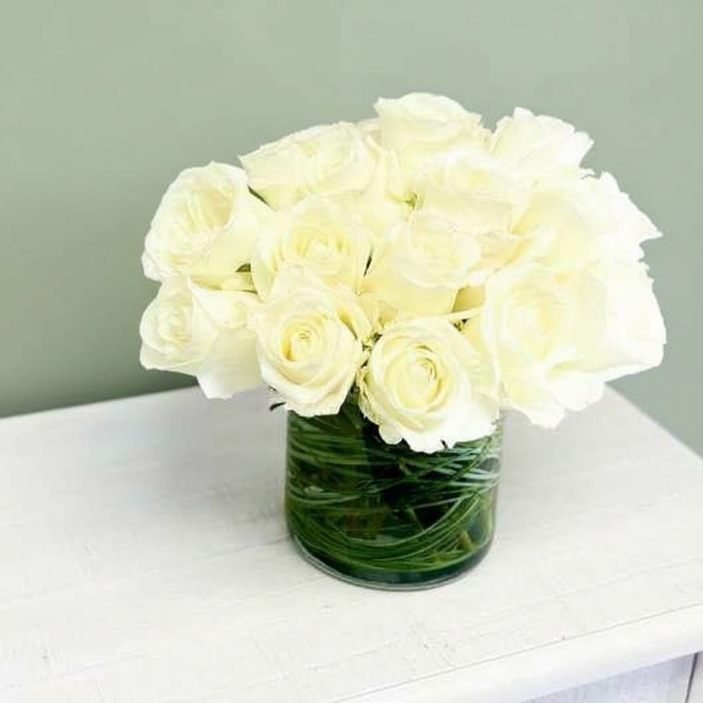 24 White Roses  - Make a bold statement with this elegantly simple design. White roses symbolize hope, honor, adoration, and innocence. Two Dozen White Roses is the perfect gift to welcome new beginnings or show your respects.    Thanks for shopping local!
