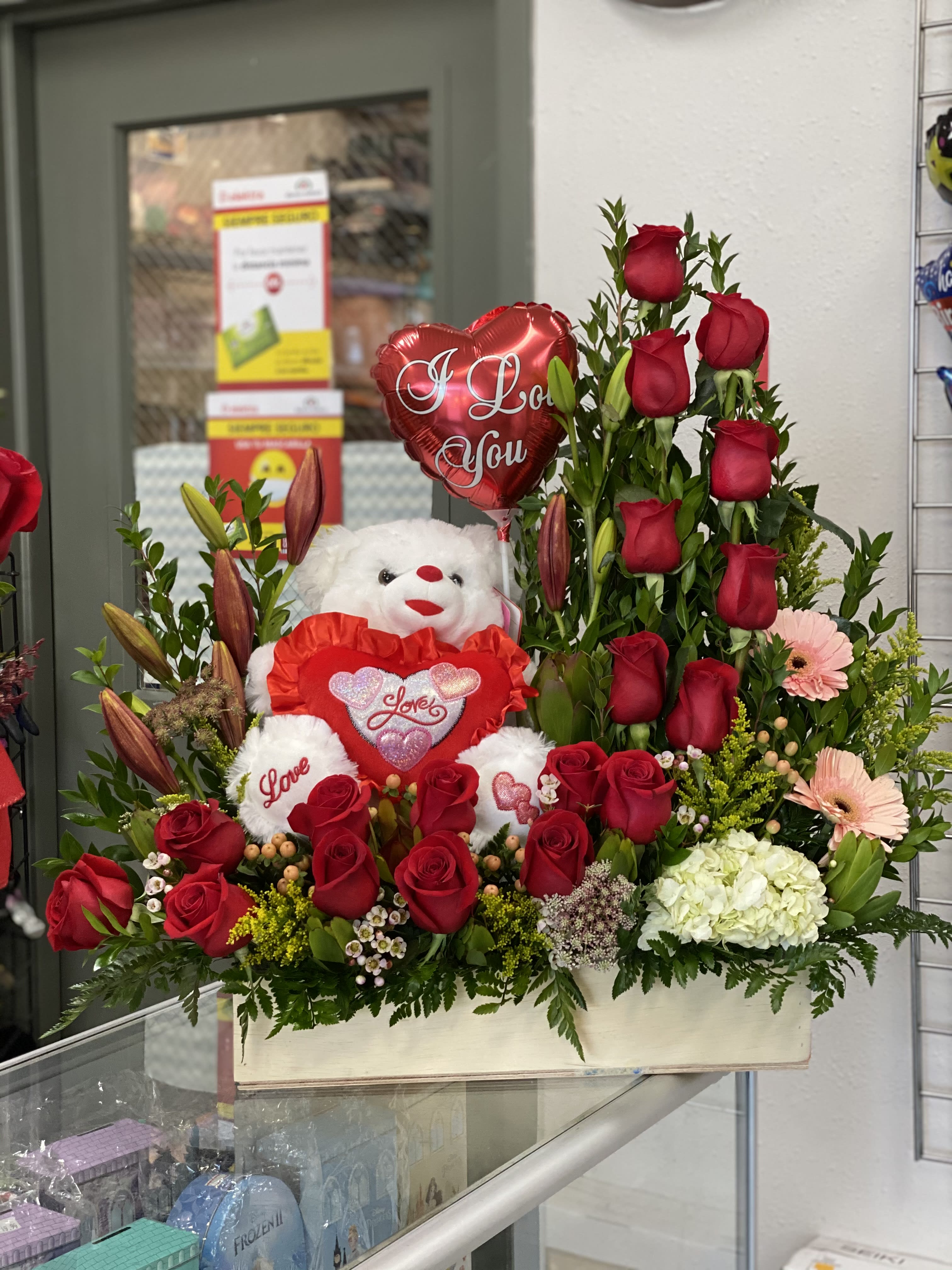 Bear and Large Curve of Roses - Includes:  9&quot; Balloon, 18 Roses (Standard) and a 9&quot; Plush Bear. This sits in a 18&quot; x 8&quot; custom made wood box and floral foam. Red roses included but you can request change in color in Instructions. 
