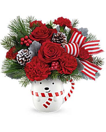 Teleflora's Send A Hug® Beary Wish Bouquet - Send cozy Christmas cheer with the Beary Wish Bouquet! Festive red blooms and winter greens fill a sweet bear mug-an unforgettable holiday gift full of warmth and joy. Beary Wish Bouquet features red roses, red carnations, red miniature carnations, dusty miller, Douglas fir, and white pine-arranged in a festive keepsake bear mug for the perfect holiday surprise.