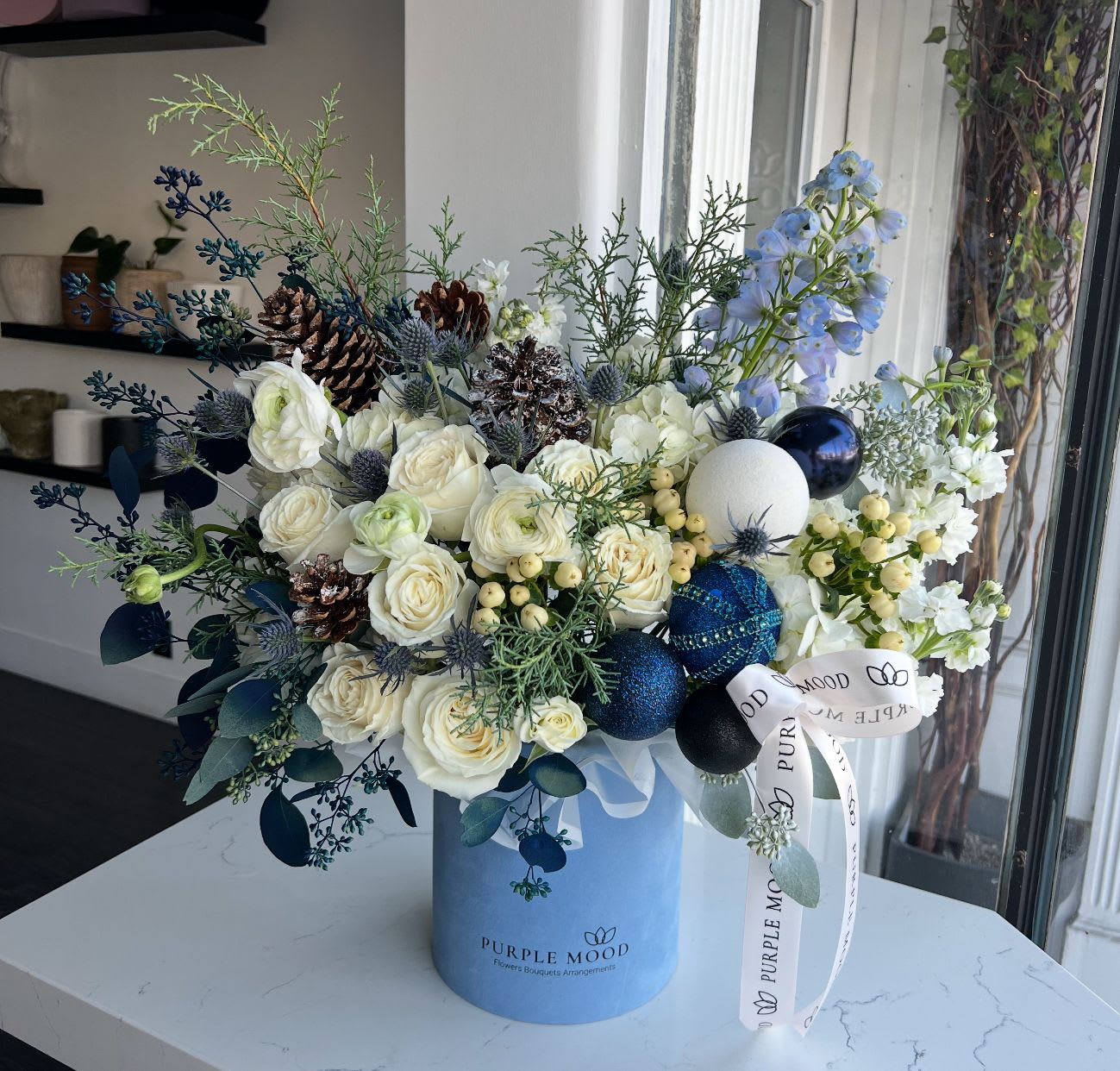 Deep Blue Christmas Box - Box with flowers, Christmas greens and decor. Standard size same as pictured. Box included wet floral foam inside, box doesn’t require vase. Lid in a back.