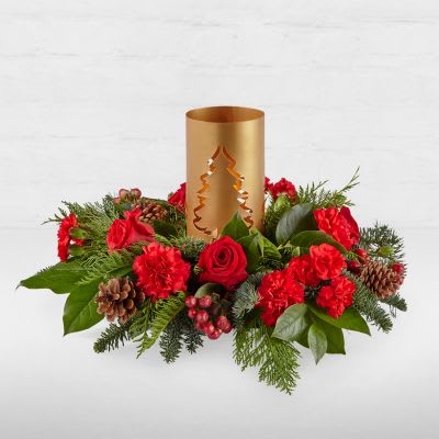 Evergreen Glow Centerpiece - Add blustery cheer to any holiday table with this coniferous centerpiece studded with cardinal-red flowers and berries gathered around a glowing candlelit tree lantern,.