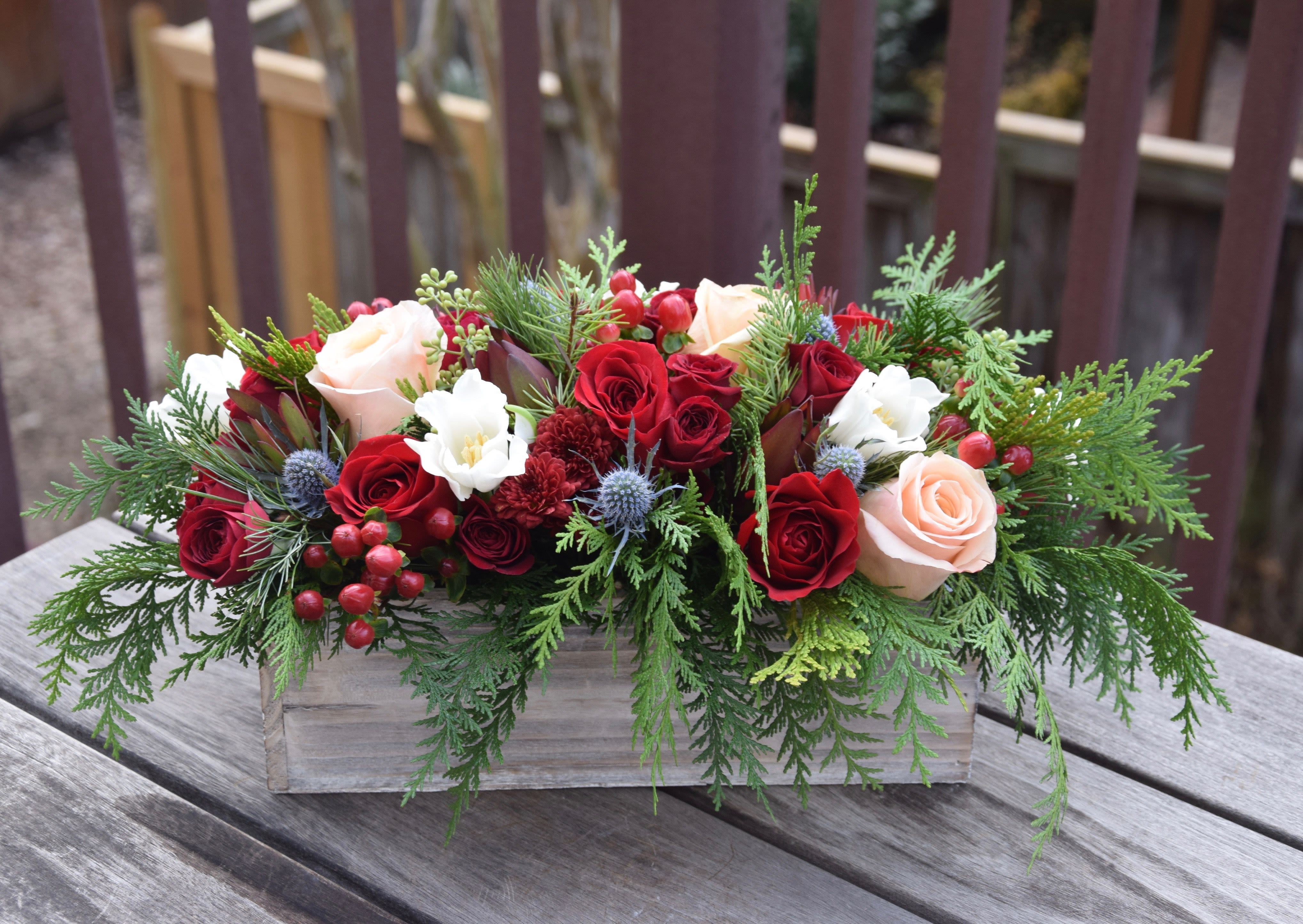 Box of Christmas Joy - Our wooden box filled with christmas greens, with a mix of textures and colors to compliment each other makes up this festive centerpiece.