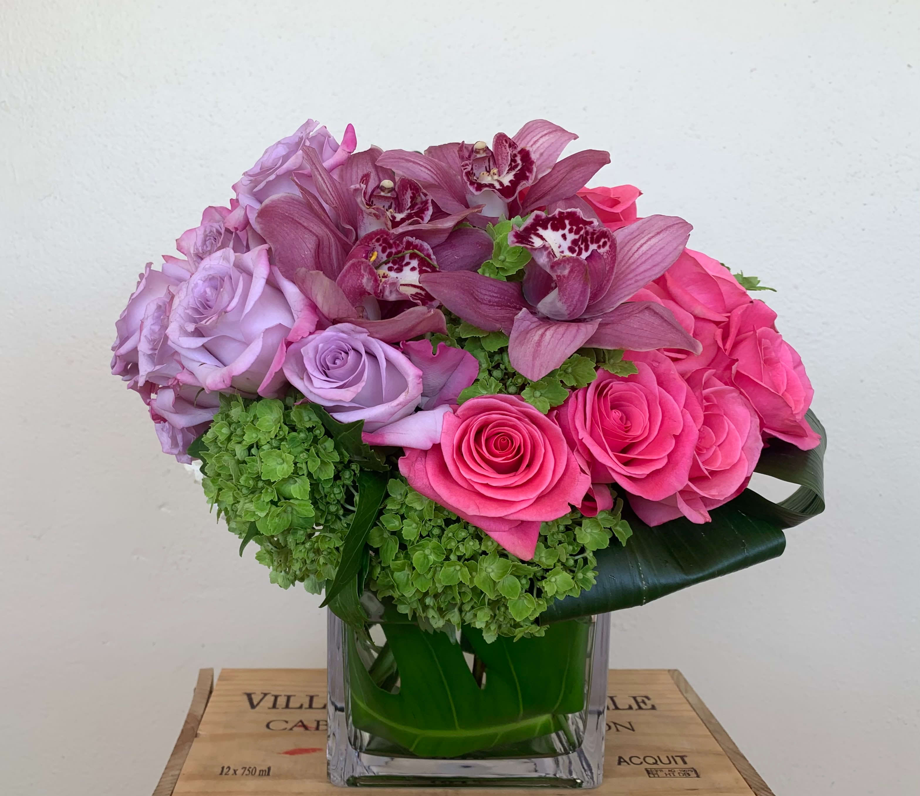 Celebration  - Mixed color Roses, Orchid blooms , Hydrangeas in 6x6 glass vase 