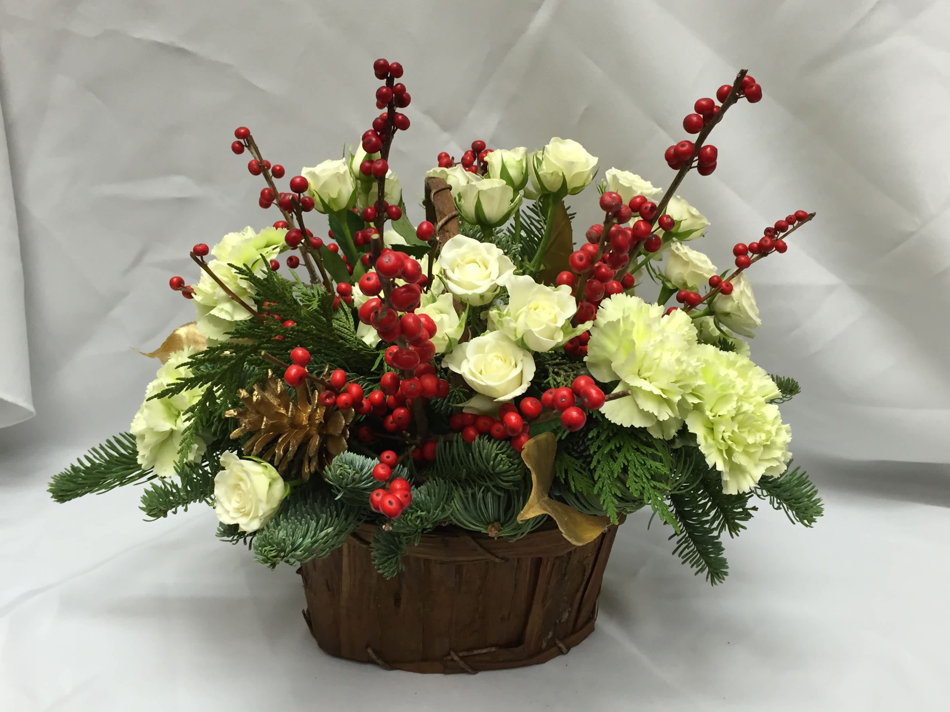 Berry Basket - Traditional winter berries are the focus of this bark basket. Flower selection and colors  may vary based on desired price but you'll always have fresh winter greens and pine cones.