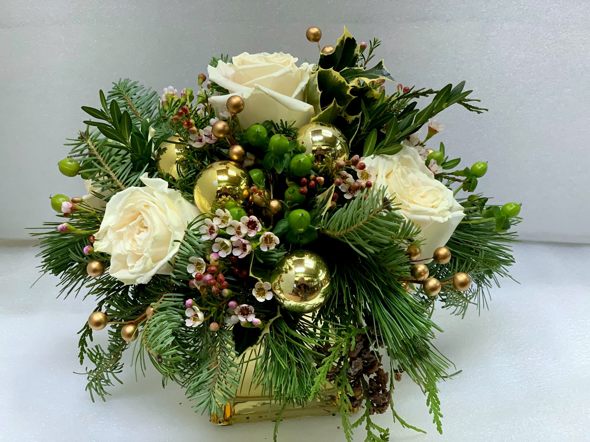 Holiday Gold - Gold cube with winter greens, white flowers and gold accents. Can be designed with red flowers too...or just a lavish mix of holiday accents.