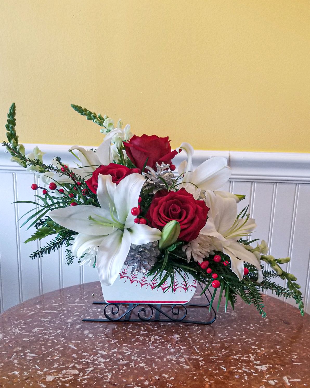 Joyous Sleigh Ride - Fly into Christmas Eve with this dashing Bouquet designed in a festive white and red sleigh. All your holiday favorites will drape over the playful reindeer, bringing the Christmas spirit to any room.
