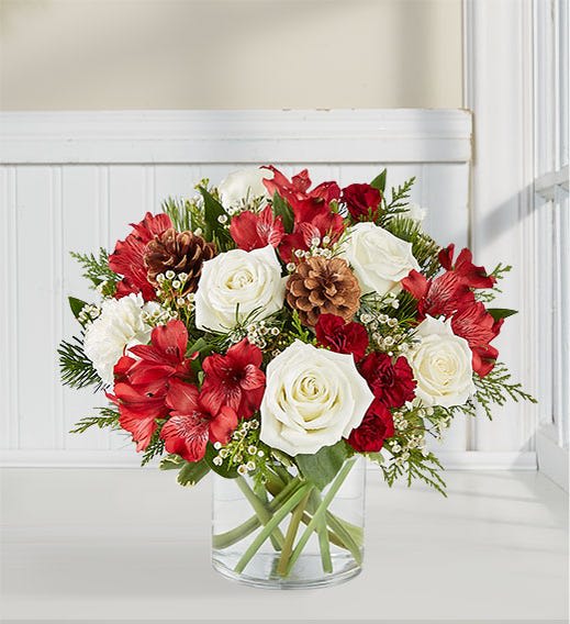 Spirit of the season - clear vase with holiday color flowers