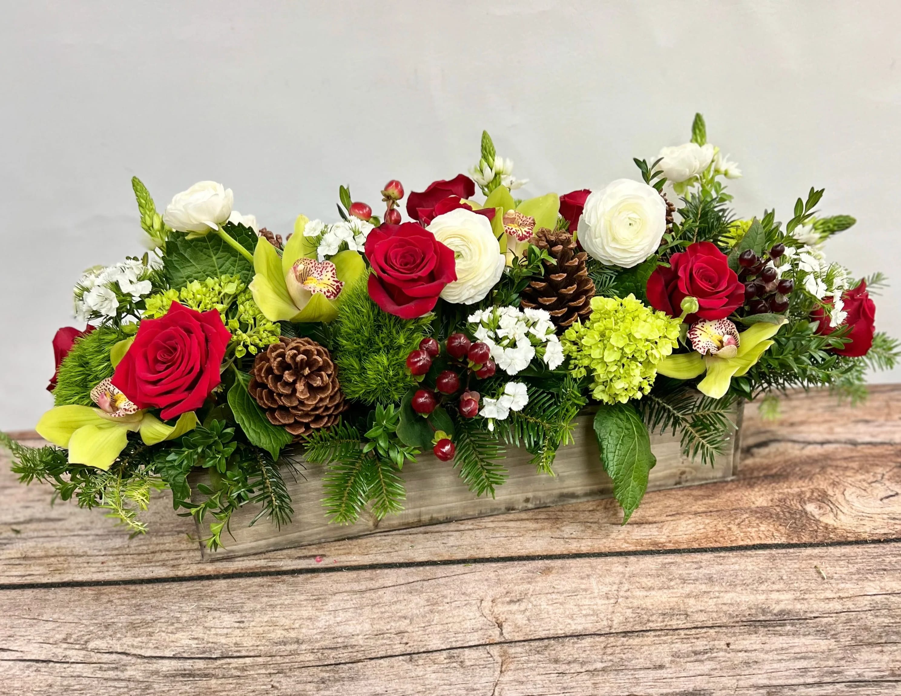 Holiday Centerpiece - A magnificent centerpiece. Send to your hostess as a special gift. Or let it grace your own table. Approximately 24&quot; long, this display is packed full of winter's freshest blooms.