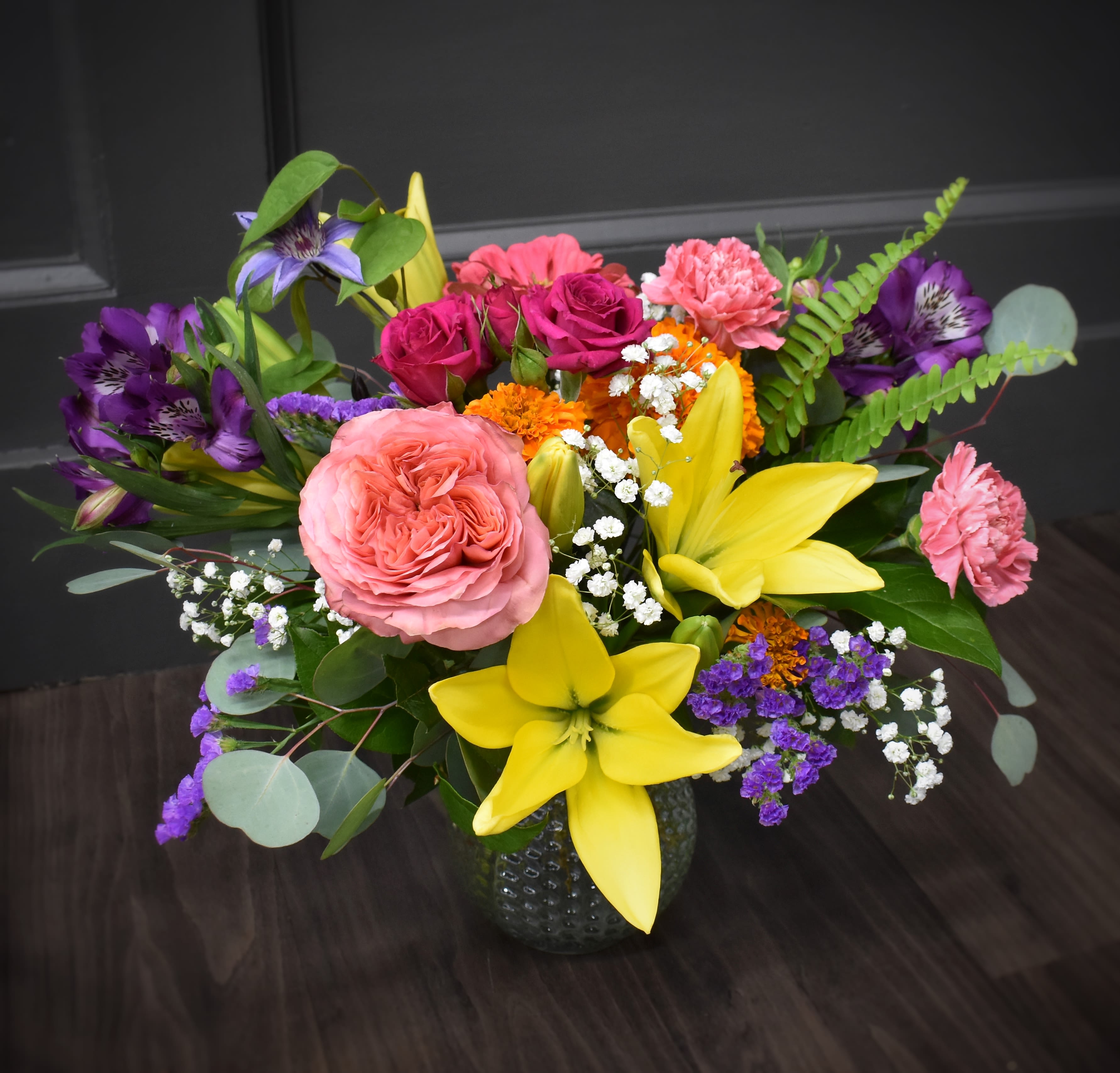 Color Splash! - A delightful symphony of summer's best blooms, this bouquet bursts with life and color, capturing the season's cheerful essence. This bouquet may include flowers like alstroemeria, roses, lilies, carnations and garden flowers surrounded by an assortment of greenery.