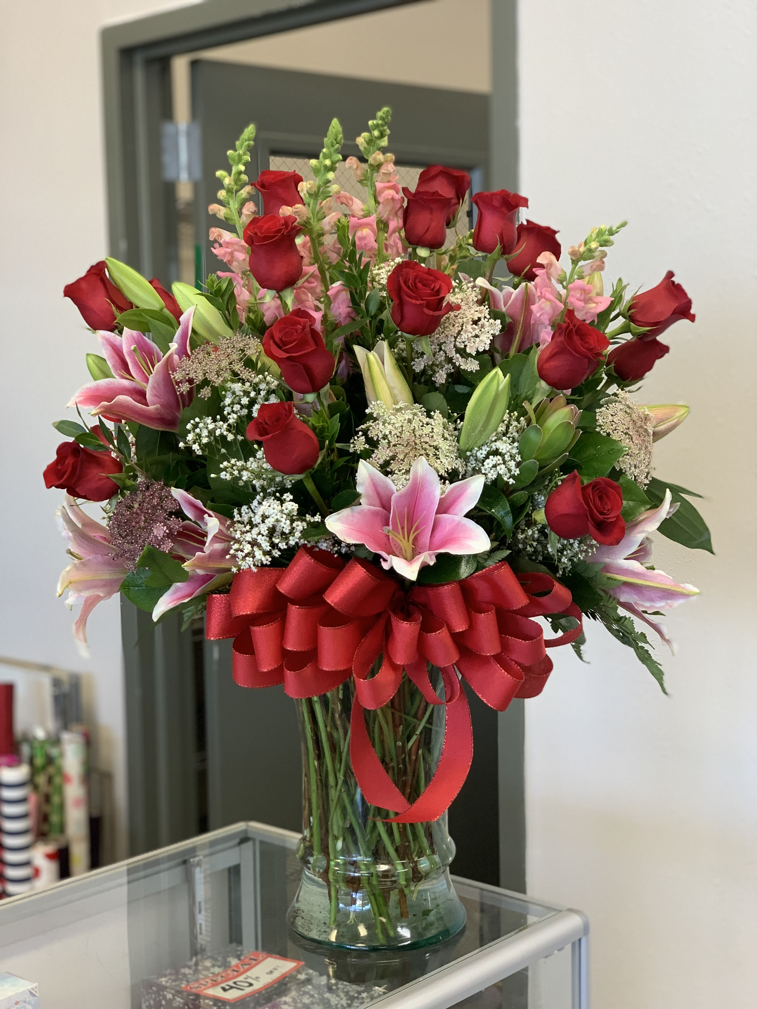 Glass Vase Lilies with Roses - Photo is example of Jumbo.//  Standard=10”Hurricane Vase// Deluxe= 13” Vase///