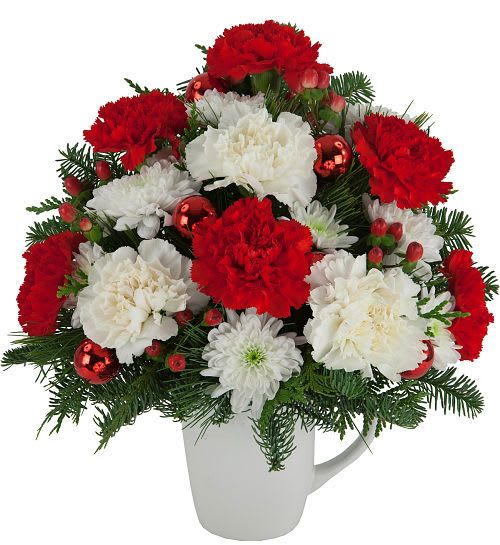Christmas Peace Mug - A re-usable mug is arranged with red and white blooms for Christmastime. Featuring an affordable and long-lasting assortment of red carnations, white carnations, red berries, white mums, ornamental balls and seasonal greens.