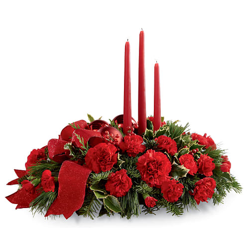 Lights of the Season Centerpiece - Lights of the Season Centerpiece is an exquisite way to bring the magic of the holiday season to your celebrations with family and friends. Brilliant red carnations and mini carnations are gorgeously arranged amongst variegated holly and an assortment of holiday greens. Accented with red glass balls and a bright red wired ribbon, this arrangement encircles 3 red taper candles to bring the perfect glow to your festivities!