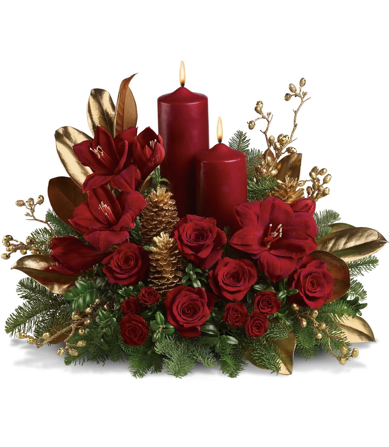 Candlelit Christmas - Ruby red amaryllis, roses and spray roses are perfectly arranged with golden pinecones and holiday greenery. Two pillar candles in a stunning shade of pomegranate are the perfect touch to light up the night. Approximately 23" W x 18" H