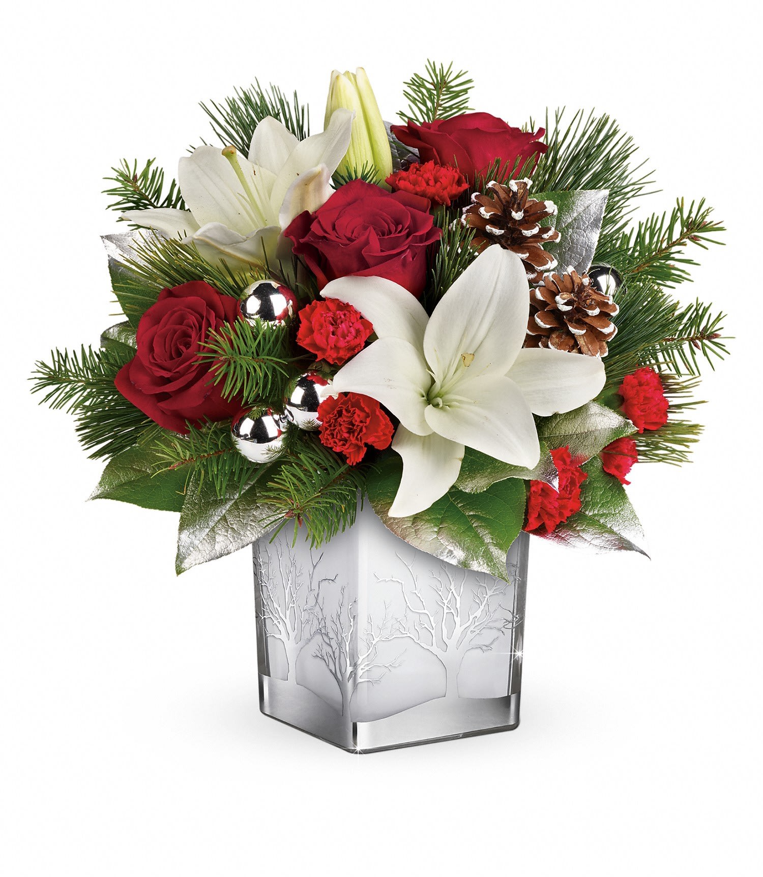 Frosted Forest Bouquet - With its festive charm and classic Christmas style, this hand-arranged bouquet delivered in a gorgeous glass cube with silver tree details is a delightful holiday surprise. Red roses, white lilies and red miniature carnations are accented with douglas fir, white pine, and lemon leaf. Delivered in a Woodland Winter cube. Approximately 13 1/4" W x 12 1/4" H