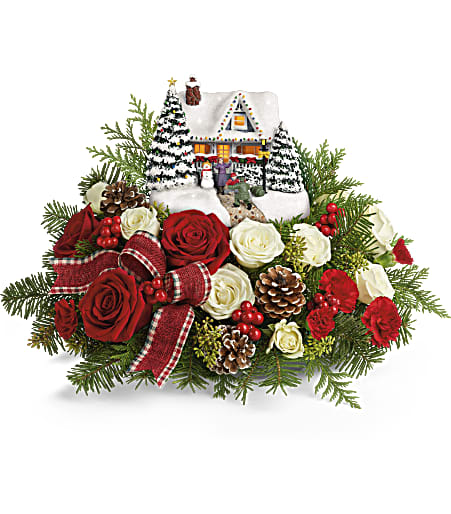 Thomas Kinkade's Homecoming Hero Keepsake Bouquet - Home for the holidays! An instant Christmas classic, this lush arrangement of red roses and fresh winter greens accompanies a festively patriotic Thomas Kinkade collectible with light-up windows and hand-painted details.