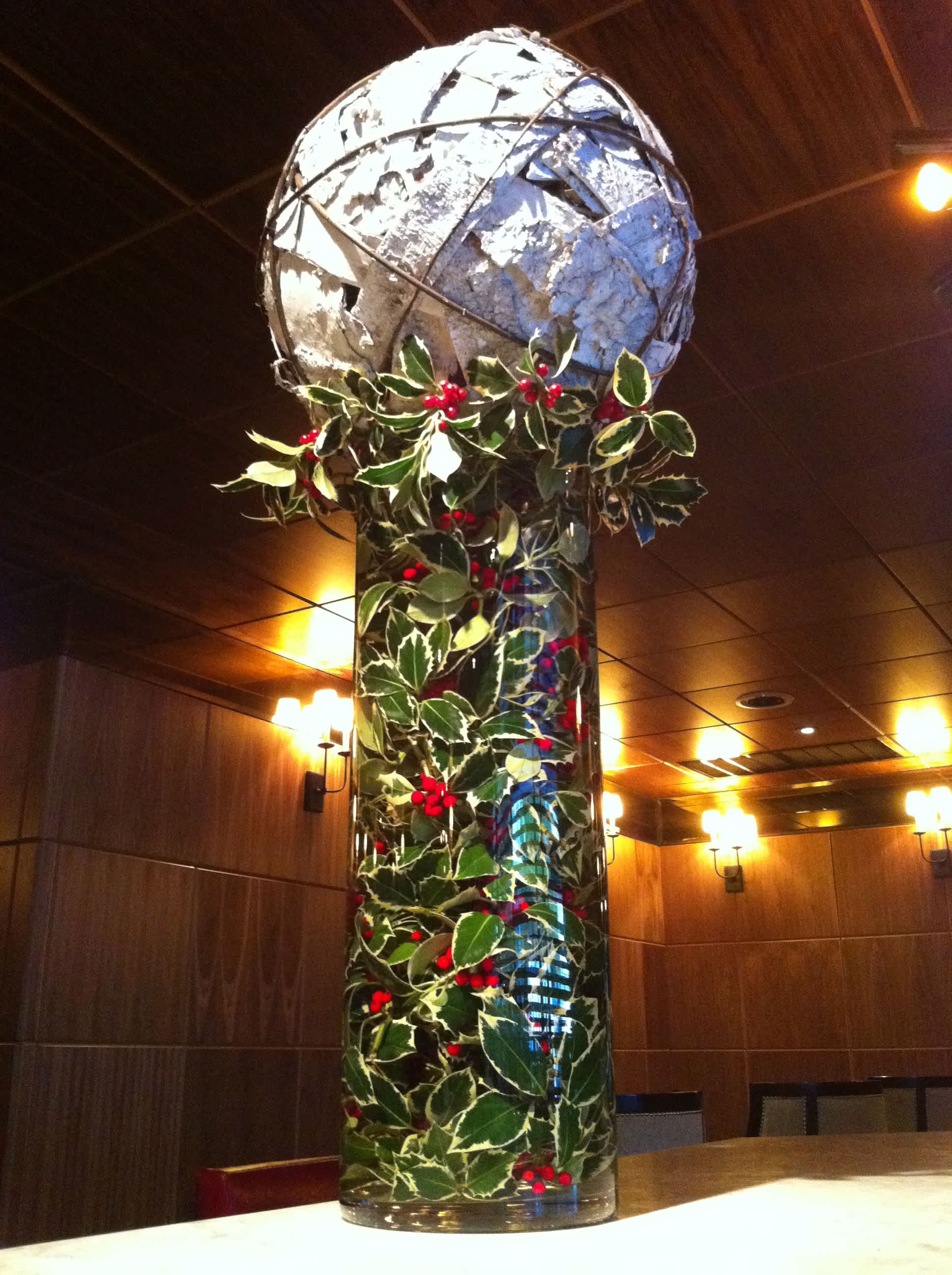 The Christmas Ball - Oversized White Birch ball is sits a top of a tall vase filled with Christmas Holly. Statement piece for sure. Large scale. 