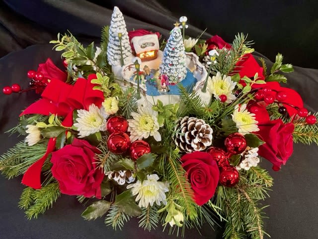 Vintage Thomas Kinkade   - A vintage Thomas Kinkade ice skating rink adorned with Winter greens, pinecones, red roses, and white accent flowers. Makes a perfect hostess gift or a gift for yourself! 