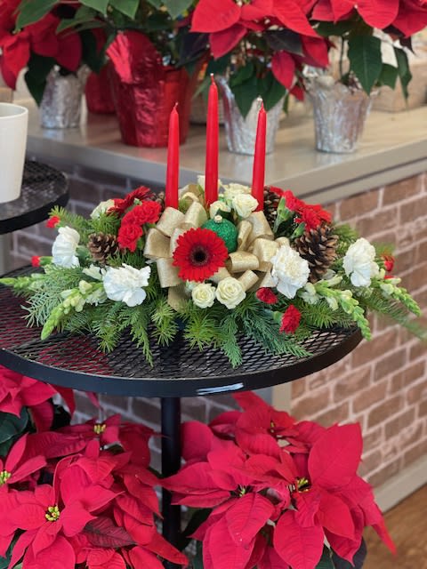 Golden Candle Centerpiece - Red, white and green Centerpiece with red candles and gold bow and pinecones. 
