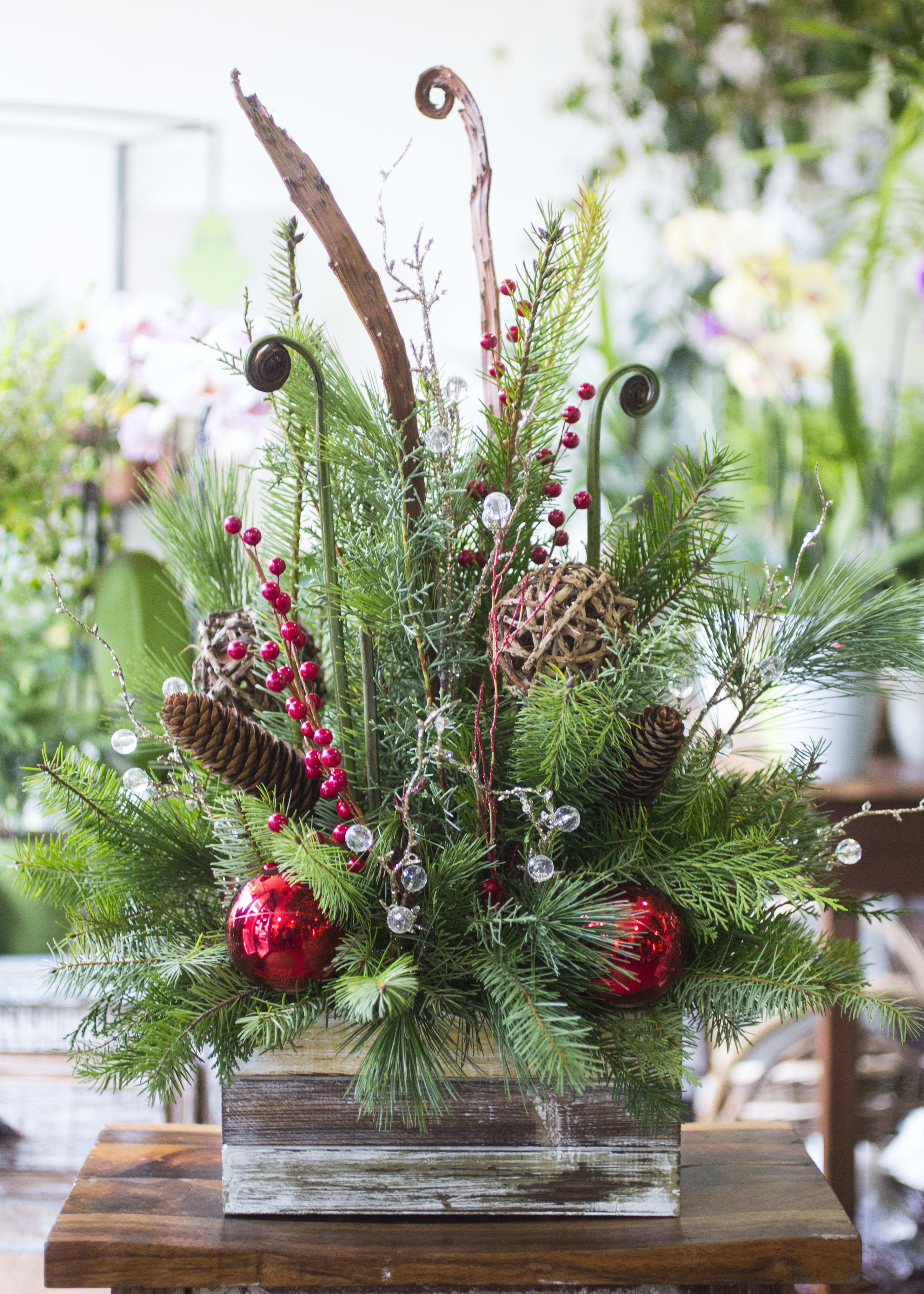 Forest - Winter greens and ornaments in a wooden box.