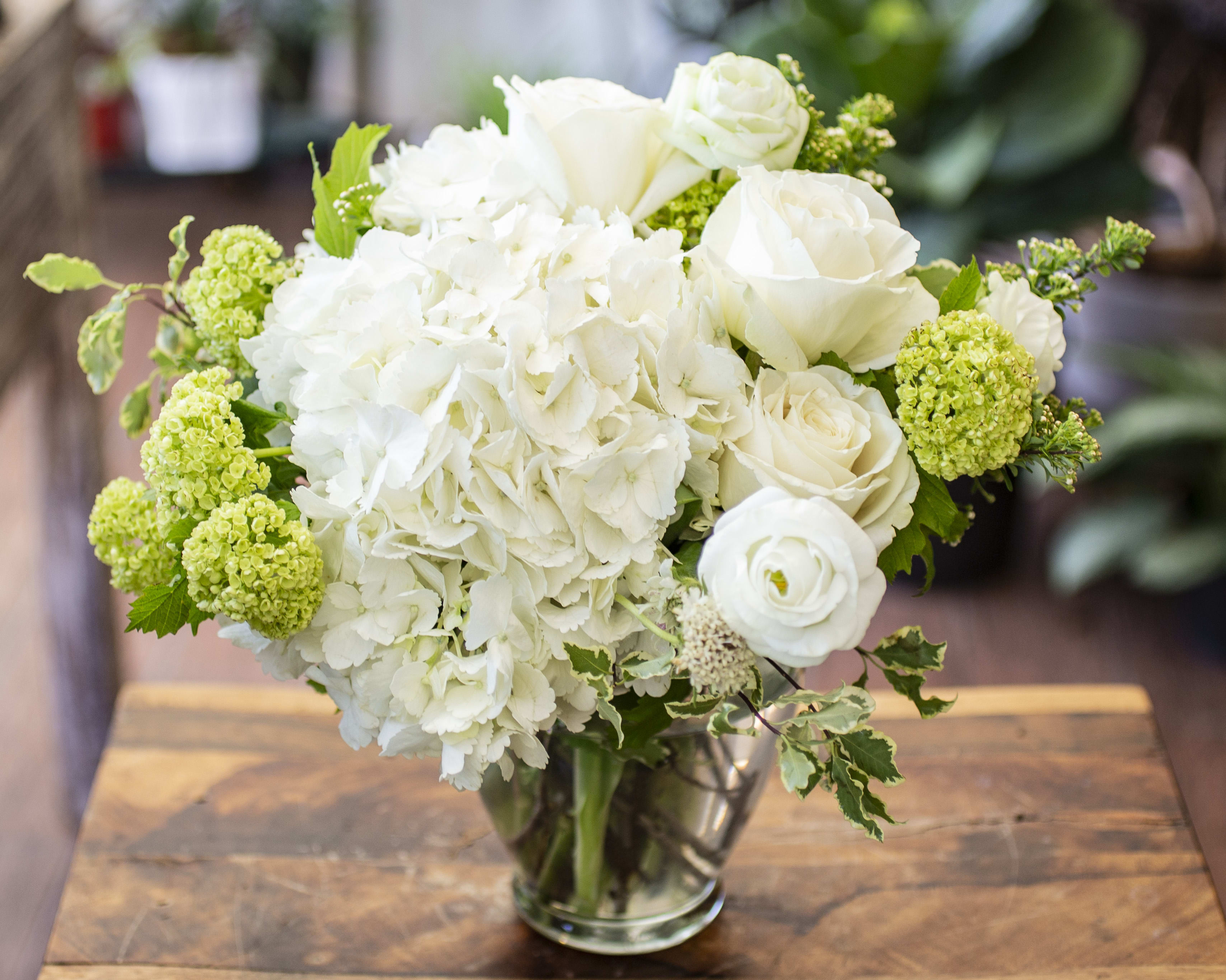 Susie - Gentle arrangements with whites and greens. 