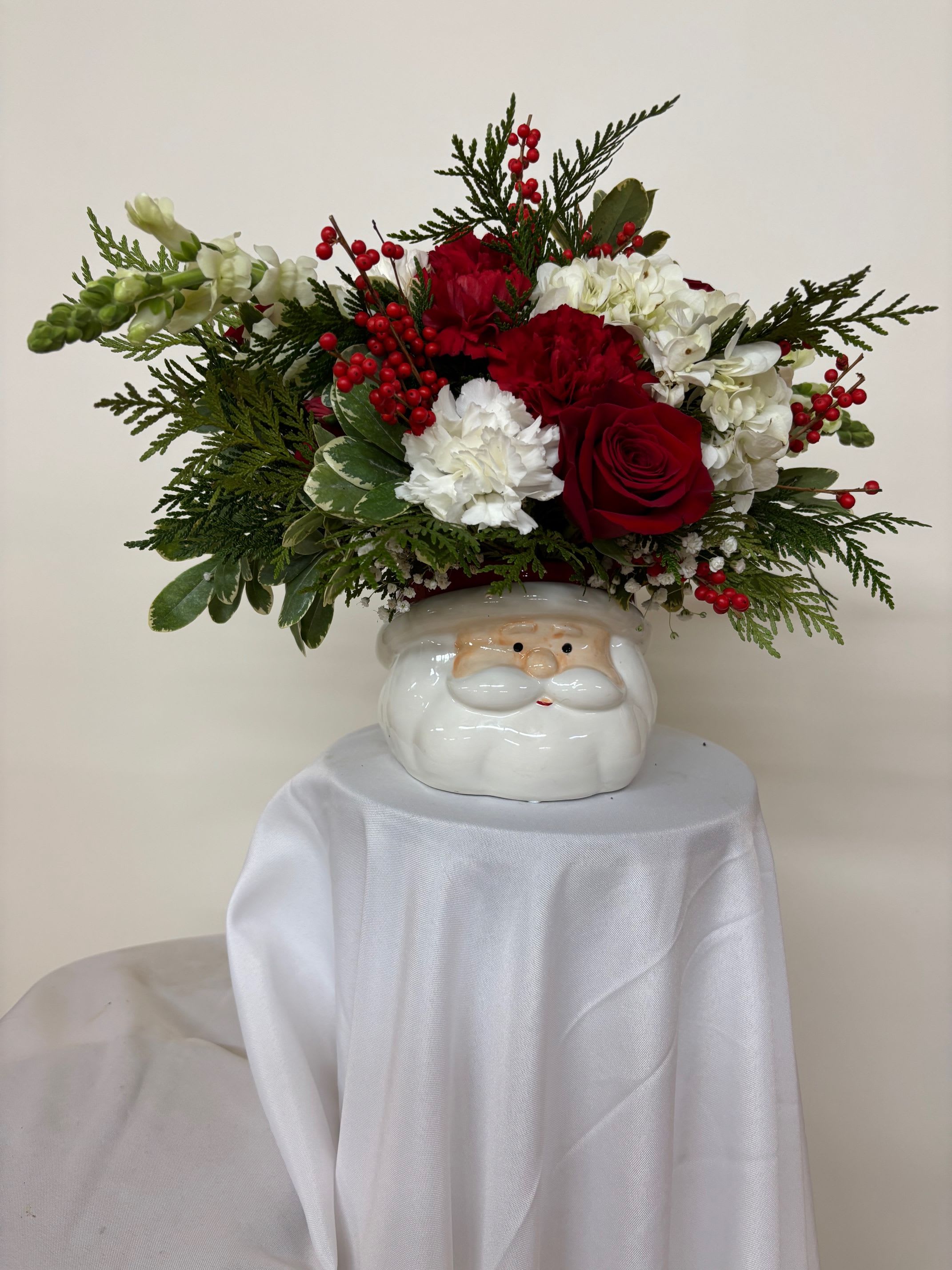 Santa's Flower Cap - Santa ceramic with a crown of red and white carnations, roses, and chrysanthemums