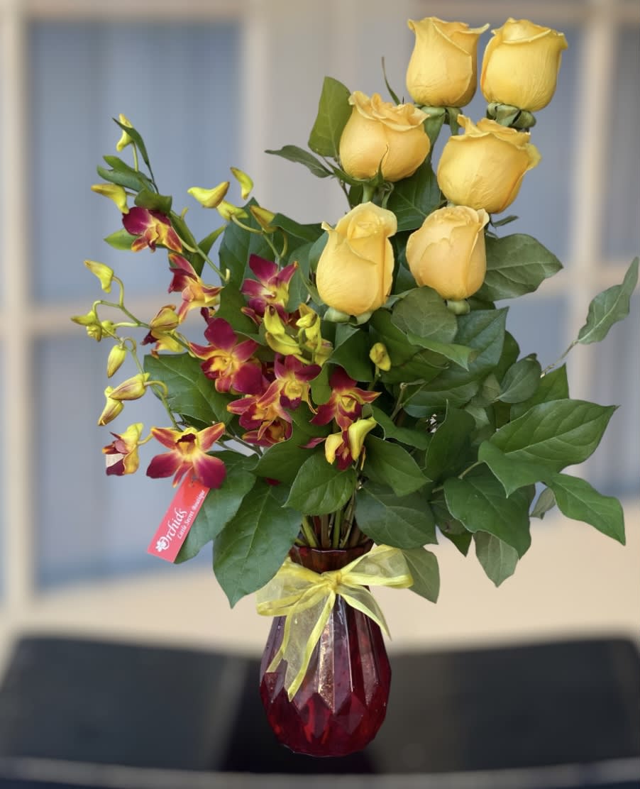 Yellow  Roses &amp; Fire Yellow Orchids Tropic Sunrise Bouquet - Give them a taste of the tropics with  warmth of sunshine tropical weather and good vibes with  Tropic Sunrise Bouquet. Featuring exotic dendrobium orchids and yellow roses arranged in a 7"H red vase.