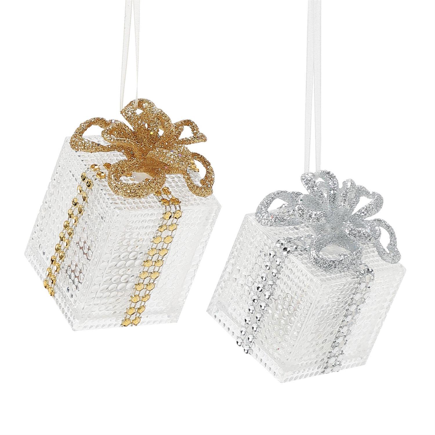 Lighted Gift Box Orn - This enchanting Lighted Gift Box Ornament glows with the warmth and wonder of The Nutcracker and the Four Realms of Christmas. Crafted from high-grade acrylic designed to mimic the brilliance of cut crystal, this miniature present sparkles beautifully by day and illuminates with a soft, magical light by night. It feels like a treasure straight from the Realm of Sweets—where surprises shine brightest and holiday magic is always wrapped with delight.  Standing 3.2 inches tall, the ornament sparkles in sunlight and radiates from within when lit, creating an eye-catching centerpiece on any tree or holiday display. Its compact size and shimmering clarity make it a perfect accent for adding a touch of glowing enchantment to the season. The ornament comes ready to shine with battery-operated lighting (3 LR44 batteries included).  Each piece is sold individually and available in limited quantities, making this luminous little gift a keepsake that brings charm, sparkle, and Four Realms magic to your holiday décor.