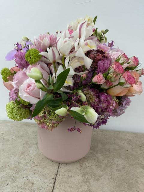 Harmonious Blend: A Designer's Choice Mix Flower Arrangement - The Harmonious Blend: A Designer's Choice Mix Flower Arrangement is a testament to the artistry of nature and the designer's creative vision. This arrangement showcases a delightful mix of flowers, carefully curated to harmonize colors, textures, and forms. It embodies the beauty of diversity and the serenity found when various elements come together in perfect balance. Join us as we explore this exquisite arrangement, where each flower symbolizes unity, creativity, and the wonder of nature.  Item: 412  &quot;Varieties and colors of flowers and planters may vary according to season and availability.&quot; Please call the shop for color options and availability.  This arrangement includes a newly cleaned vase and good quality water &amp; flower food.     Care Instructions: For the best vase life, change the water every two days.