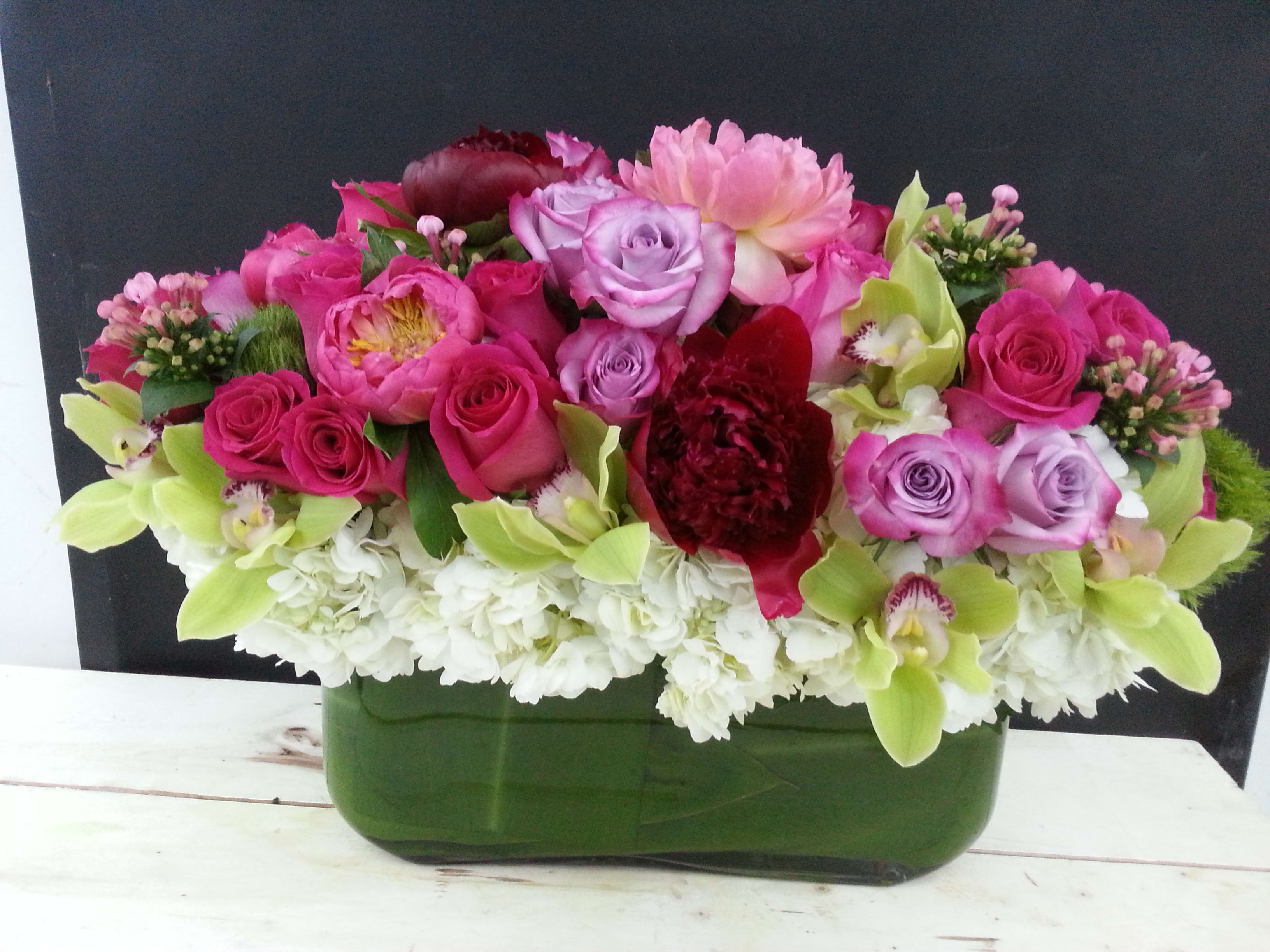 Harmonious Fusion: A Mix Premium Floral Arrangement of Beauty and Variety - Immerse yourself in a symphony of nature's finest offerings with the &quot;Harmonious Fusion Mix Premium Floral Arrangement.&quot; This arrangement is a testament to the diversity and beauty found in the world of flowers, combining a variety of premium blooms into a harmonious display that captivates the senses. With an array of colors, textures, and scents, this arrangement celebrates the exquisite tapestry of nature's bounty.   This arrangement comes with a newly cleaned vase and good quality water &amp; flower food.  Item: 135  Care Instructions: For the best vase life, change the water every two days.  Varieties and colors of flowers may vary according to season and availability