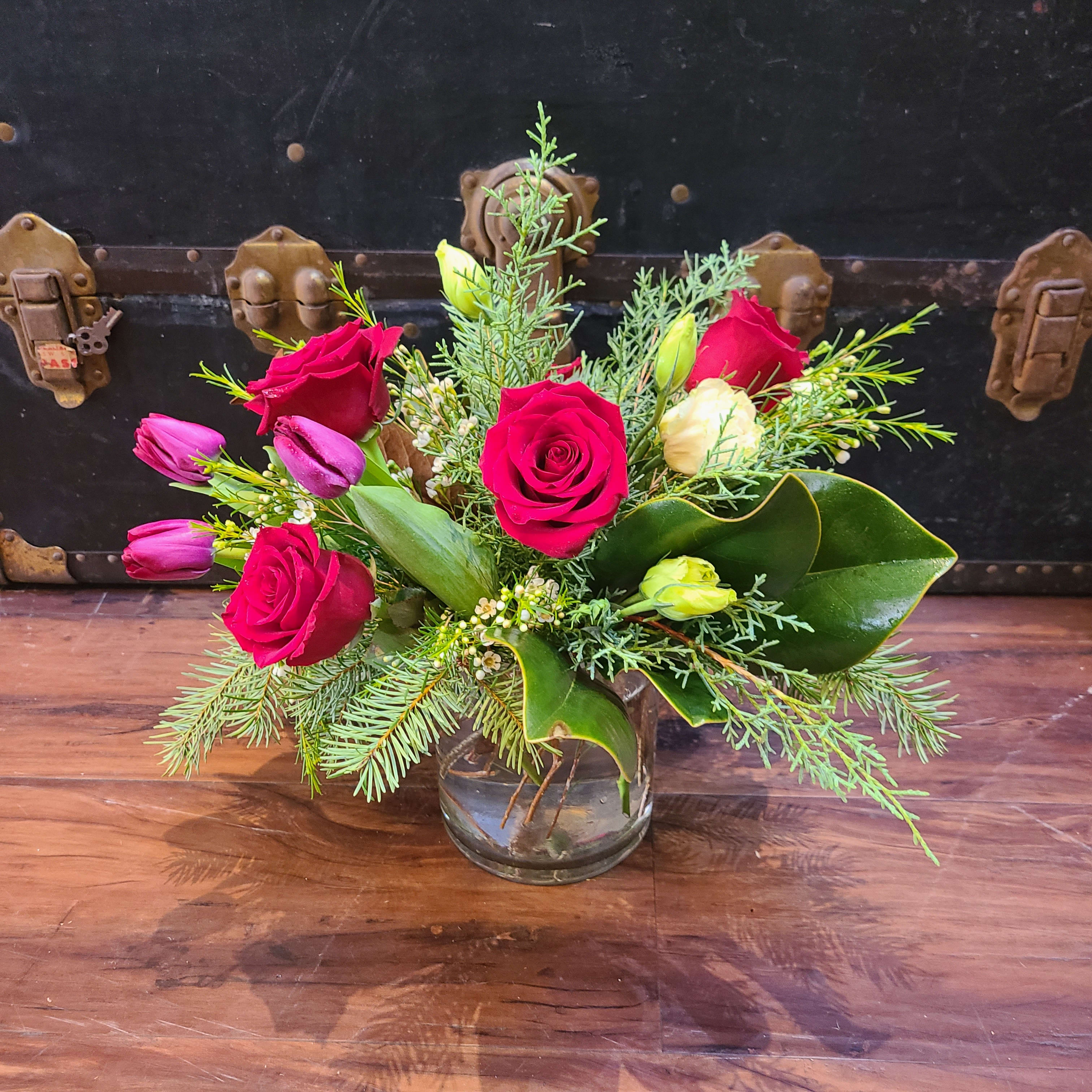 Winter on The Ave - This petite centerpiece features a variety of winter greens and splashes of red throughout. Finished size is approximately 12&quot; high, and 12&quot; wide.