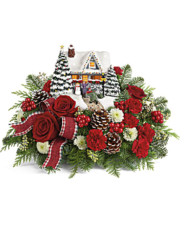 Thomas Kinkade's Hero's Welcome Bouquet - Home for the holidays! An instant Christmas classic, this lush arrangement of red roses and fresh winter greens accompanies a festively patriotic Thomas Kinkade collectible with light-up windows and hand-painted details. This arrangement includes red roses, miniature red roses, white button spray chrysanthemums, seeded eucalyptus, noble fir, and flat cedar. Delivered with the Thomas Kinkade's Hero's Welcome Keepsake. Orientation: All-Around