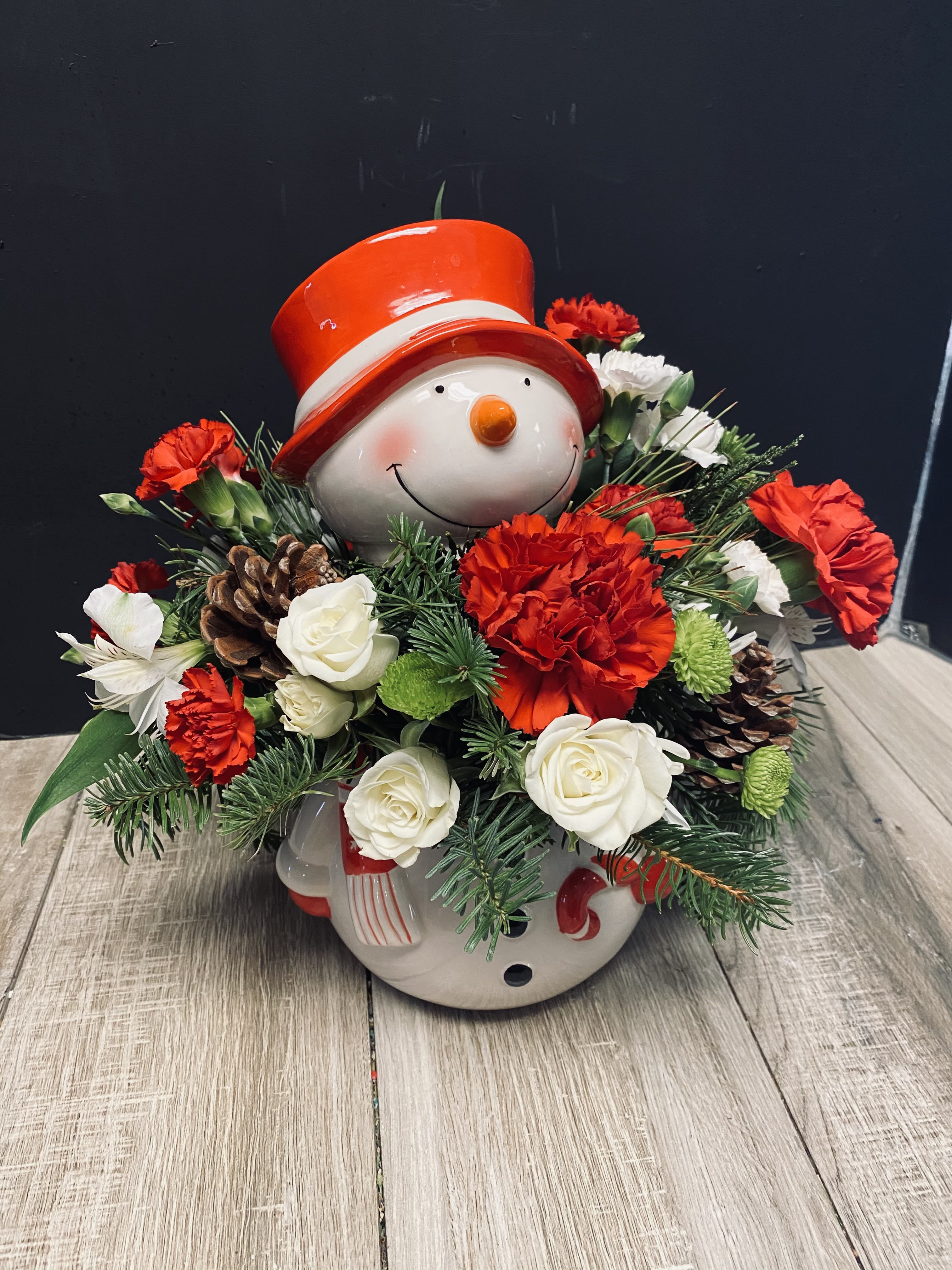 Snowman Cookie Jar - This snowman cookie jar will have heads turning, it has a stunning floral arrangement in it, then once the florals are gone you have a keepsake cookie jar. Send this to your loved ones this holiday season. 