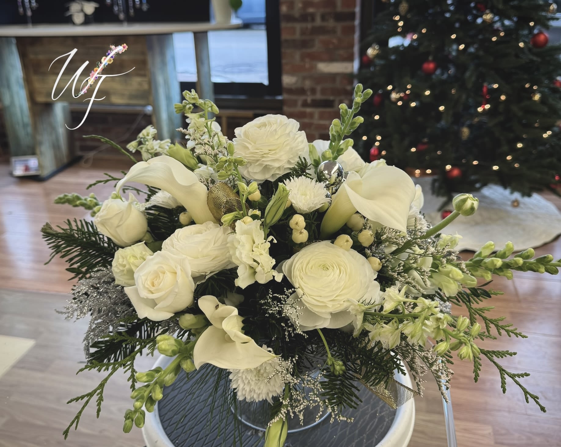 Holiday Elegance  - Clean white blooms and evergreens accent this compote vase for a gorgeous table piece 