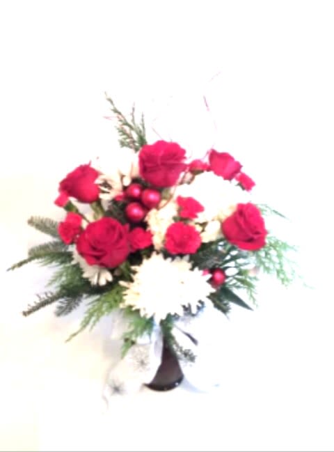 Classic Christmas - Make a classic statement with 6 roses, white mums ,red mini carnations, greenery and holiday decoration in a classic red vase