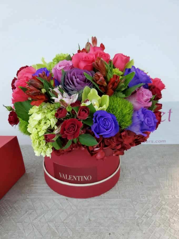 Valentino's Elegance: A Mix Color Bouquet Inspired by Love - Immerse yourself in a world of timeless romance and vibrant emotions with the &quot;Valentino Bouquet Mix Color Arrangement.&quot; Inspired by the passion and allure of Valentino, this bouquet captures the essence of love in a harmonious blend of colors and blooms. Each petal in this arrangement is a testament to the beauty of love's diverse expressions, creating a bouquet that speaks to the heart.  &quot;Varieties and colors of flowers may vary according to season and availability.&quot; This arrangement includes a newly cleaned vase and good quality water &amp; flower food.  Item: 196  Care Instructions: For the best vase life, change the water every two days.