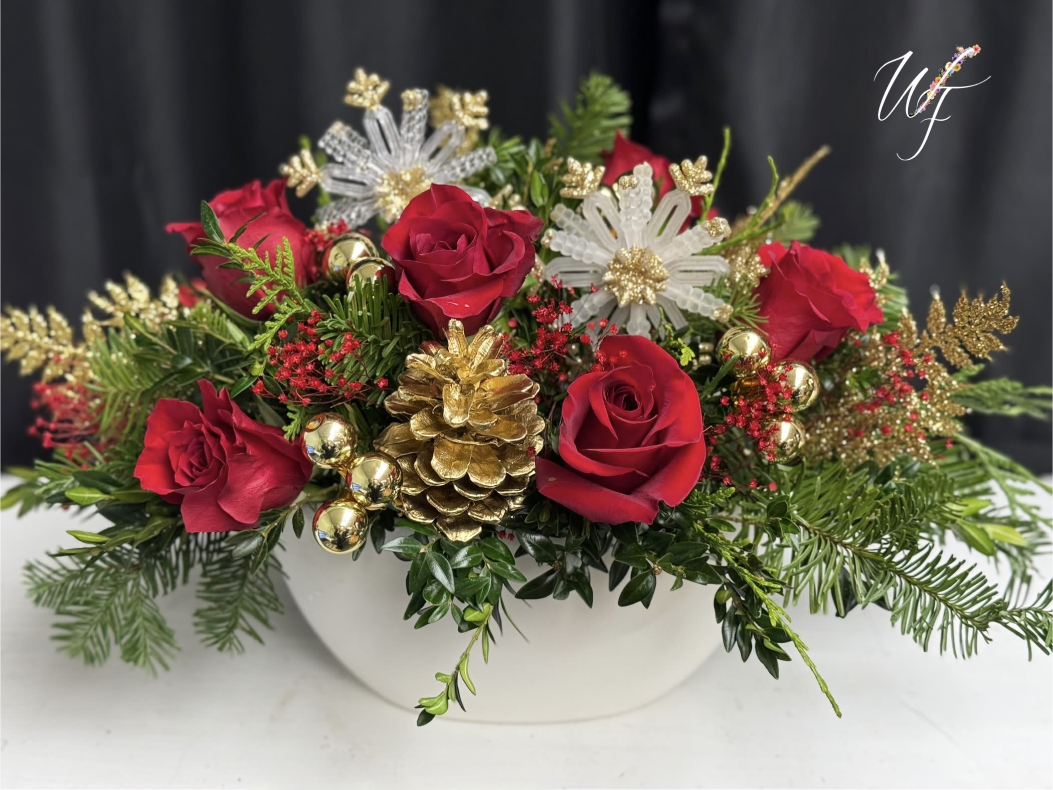Holiday Splendor  - Gorgeous arrangement containing evergreens, red florals and holiday accents for a truly stunning piece 
