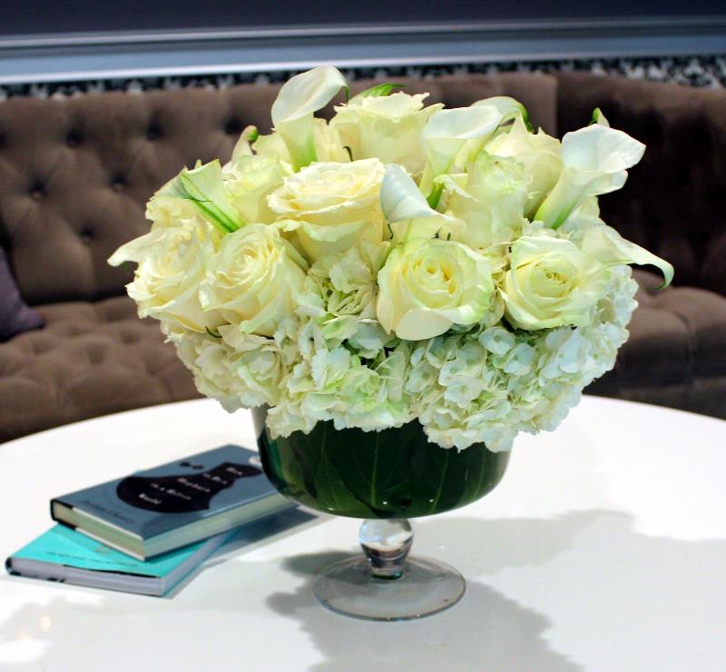 White Night Martini Arrangement: A Sophisticated Floral Toast to Elegance - Raise a toast to refined elegance with the &quot;White Night Martini Arrangement,&quot; a floral ensemble inspired by the sophistication of a classic martini. Just as a well-crafted cocktail combines elements to create a harmonious blend, this arrangement merges the pristine beauty of white blooms with the allure of a martini glass. The result is a captivating display that pays homage to both the world of flowers and the art of mixology.  &quot;Varieties and colors of flowers may vary according to season and availability.&quot;  This arrangement includes a newly cleaned vase and good quality water &amp; flower food.  Care Instructions: For the best vase life, change the water every two days.