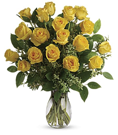 Dozen Yellow Roses (DL) - This gorgeous floral arrangement is a radiant display of sunshine and happiness, featuring a dozen stunning yellow roses elegantly arranged in a vase with lush greens and delicate filler flowers. 