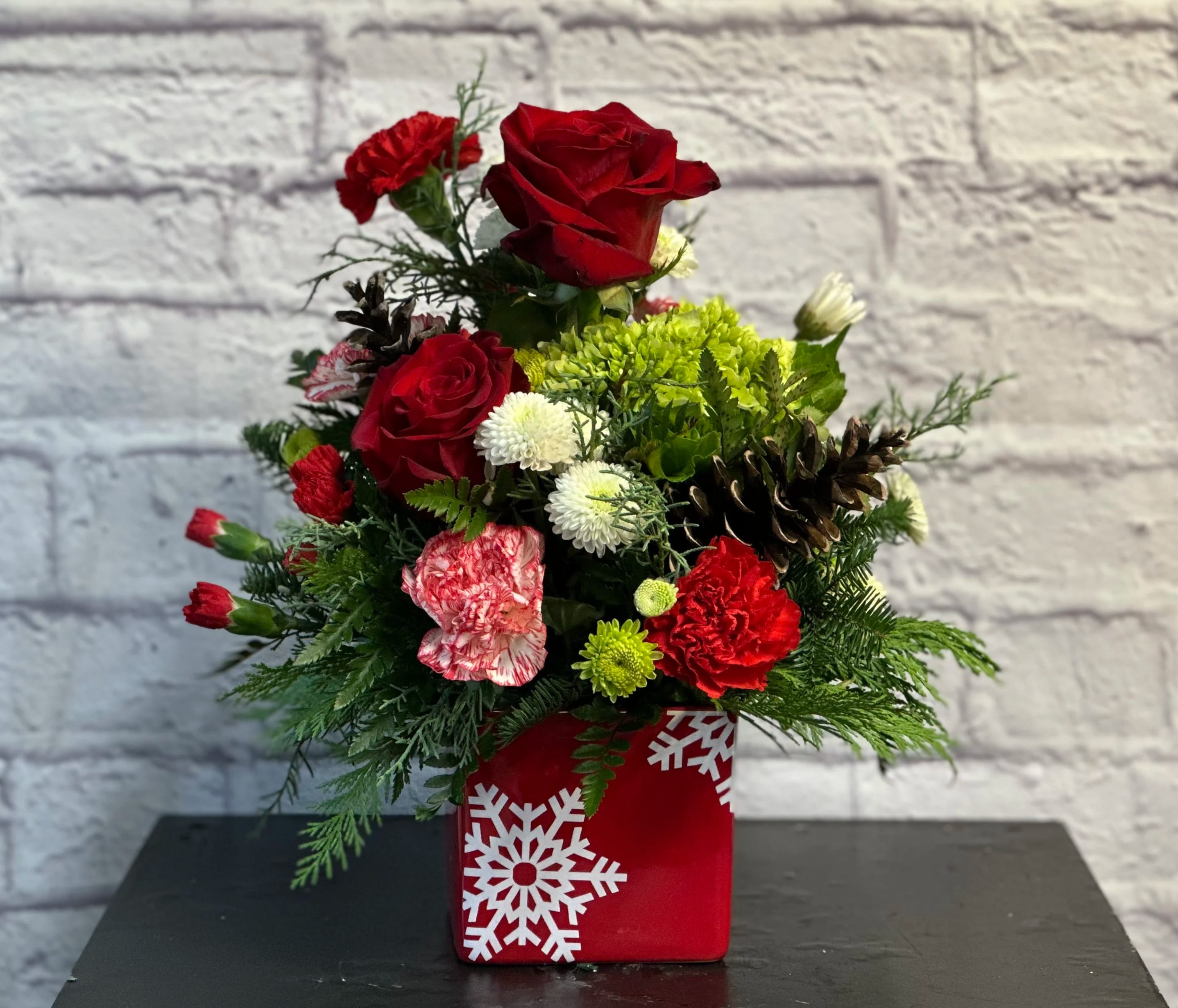 Simply Snowflakes - Our red and white snowflake container filled with stunning Christmas blooms will be a perfect way to say Merry Christmas!